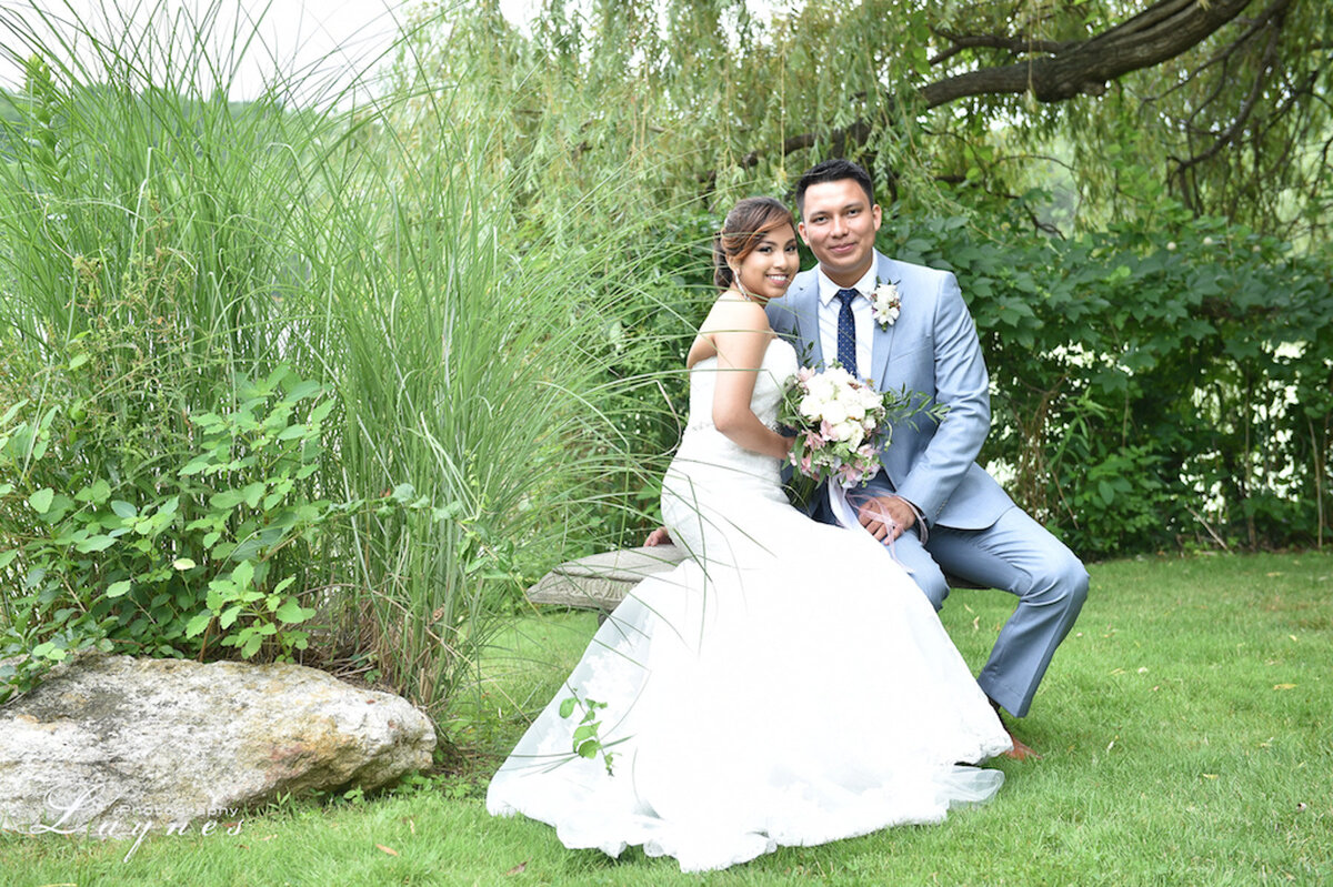 Bride and groom sharing a moment; soft glam bridal look with lashes and blush tones.