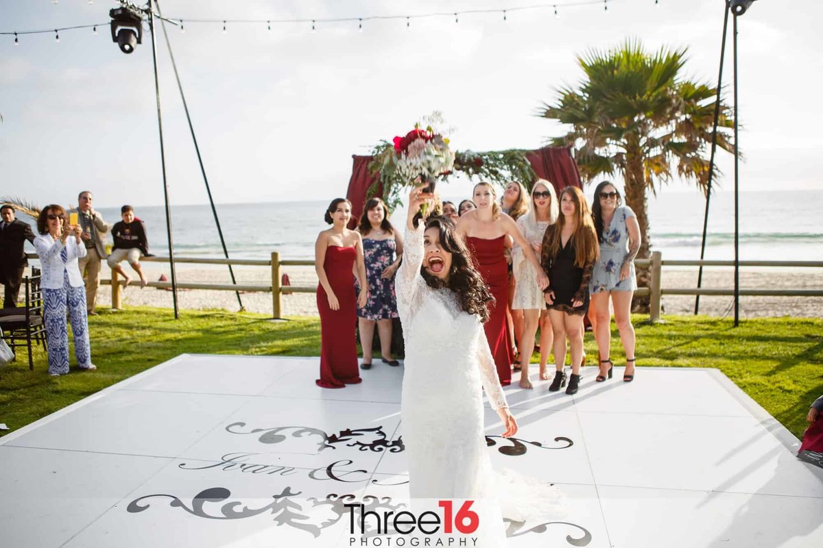 Bride lofts the Bouquet into the air to awaiting single ladies