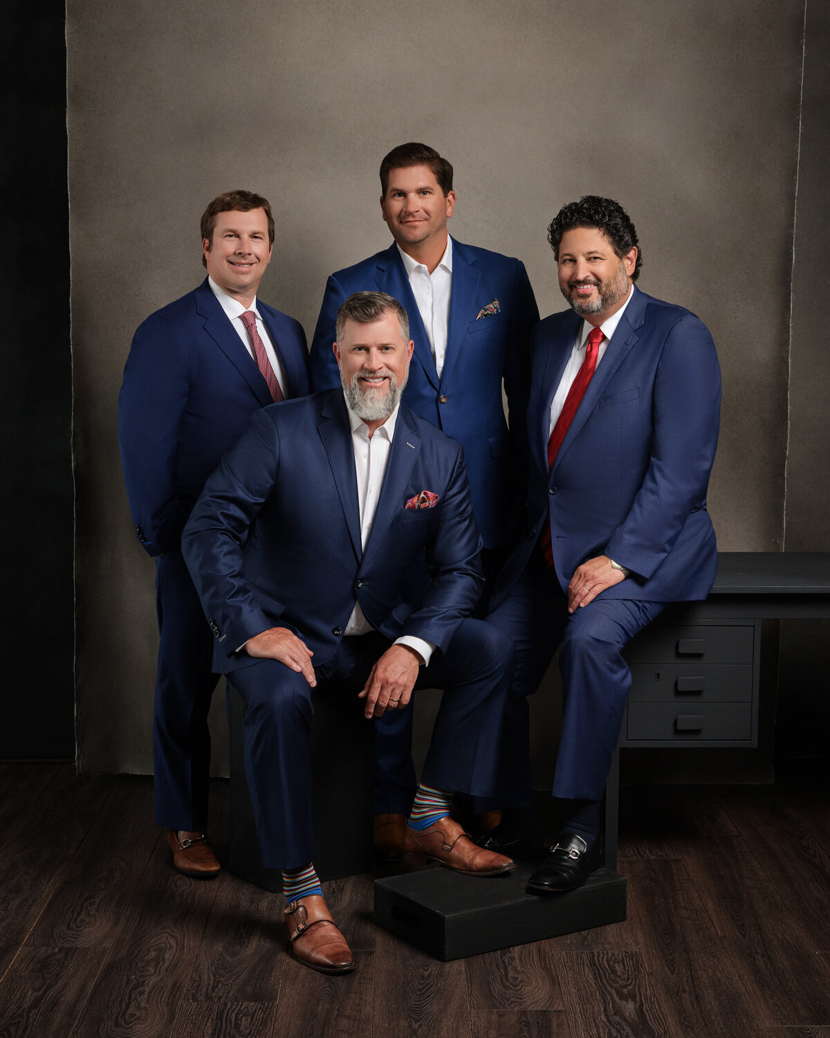 A group of men in suits smiling