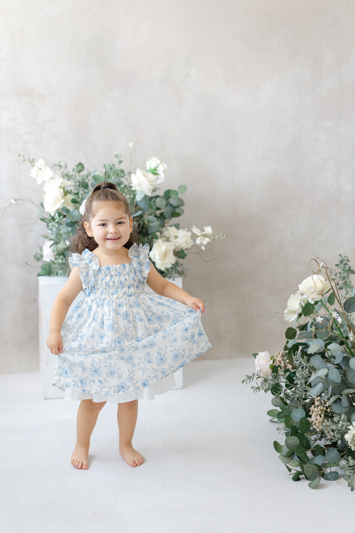 Joyful Tampa motherhood portrait of daughter dancing in soft natural light studio