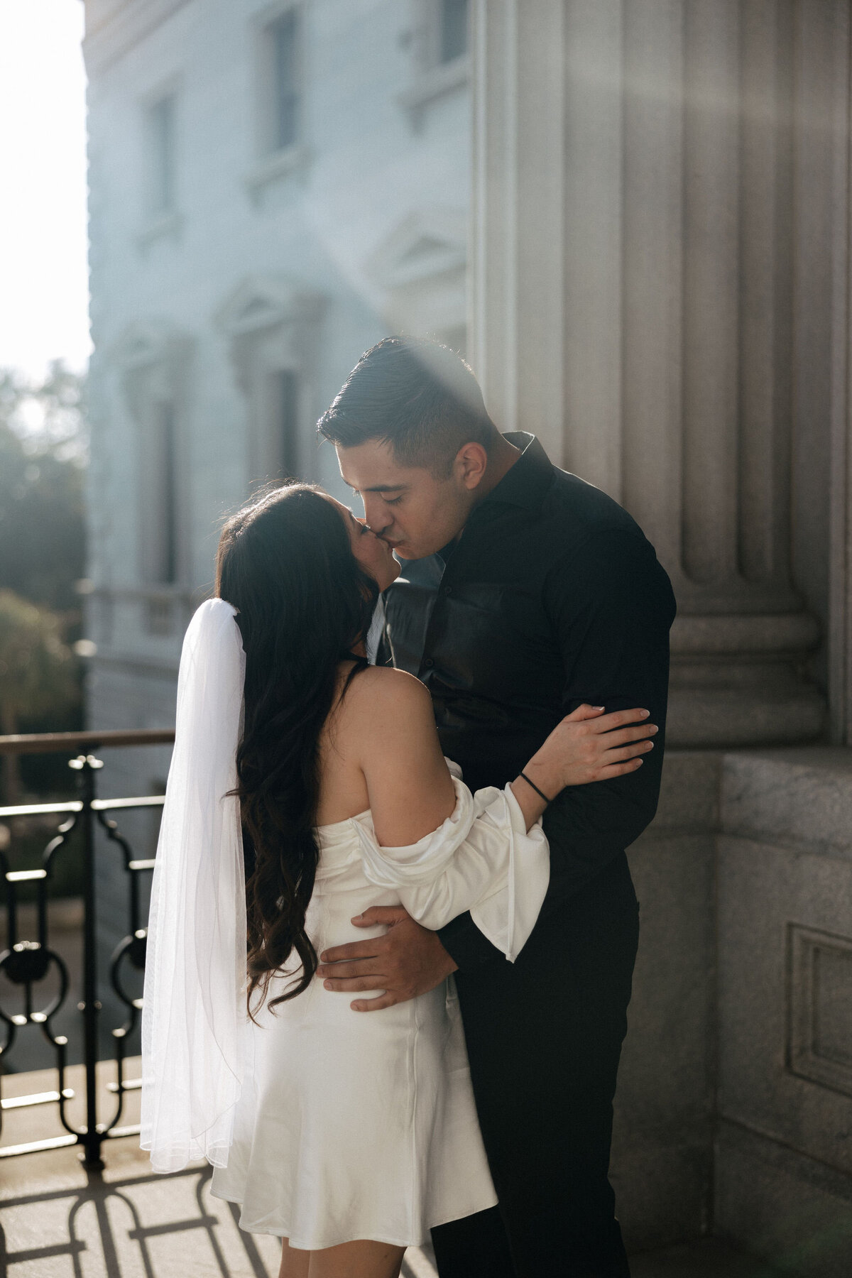 A husband and wife kiss atop the Columbia, SC State House during their sunset elopement.
