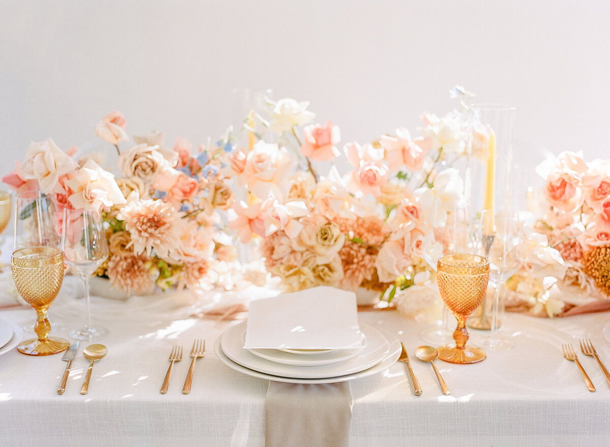 Romantic autumn floral arrangements on a wedding table top with custom place settings and menus
