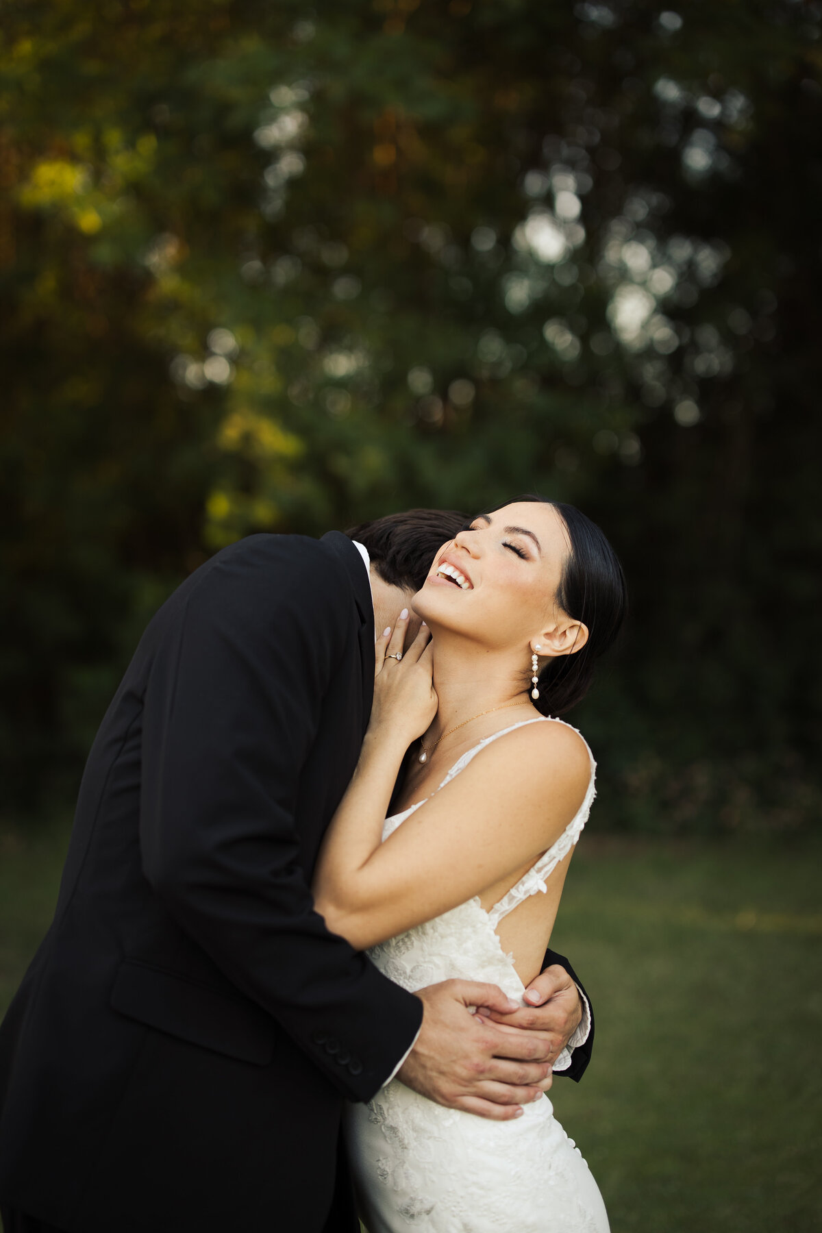 Groom kissing bride's neck