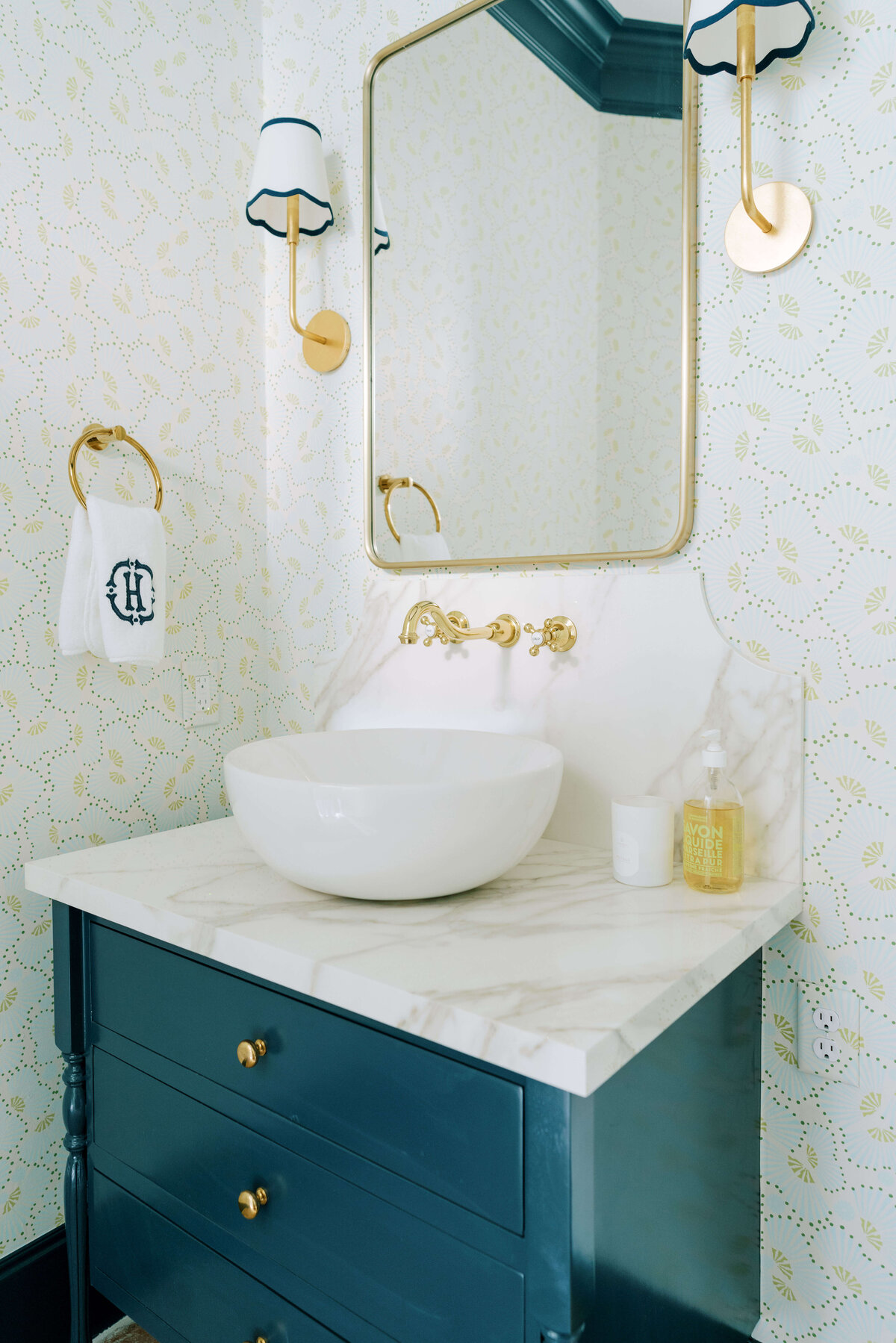 oyster creek studios hause blue bathroom with gold hardware and marble counters