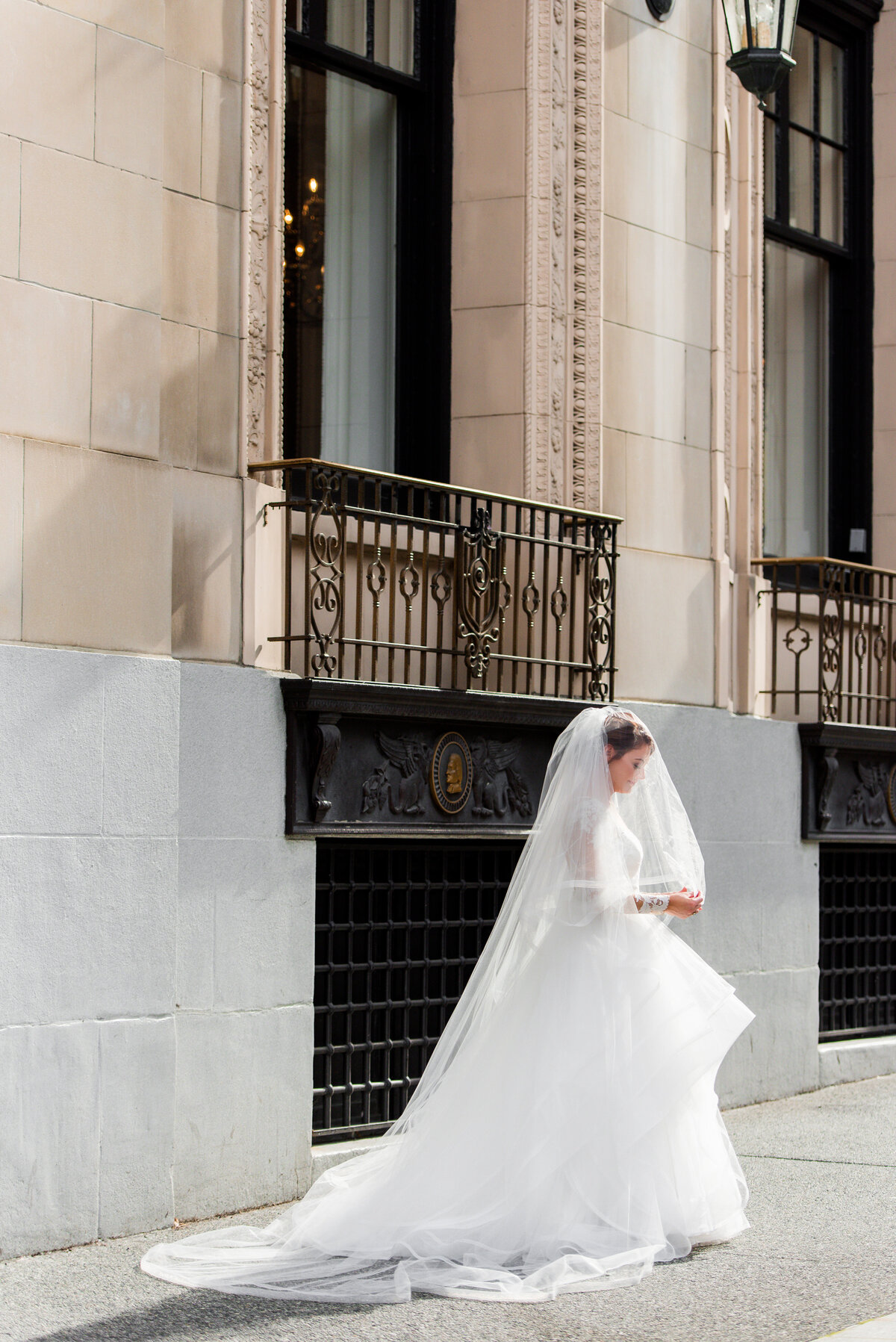 bride under veil on the street outside of the omni william penn hotel