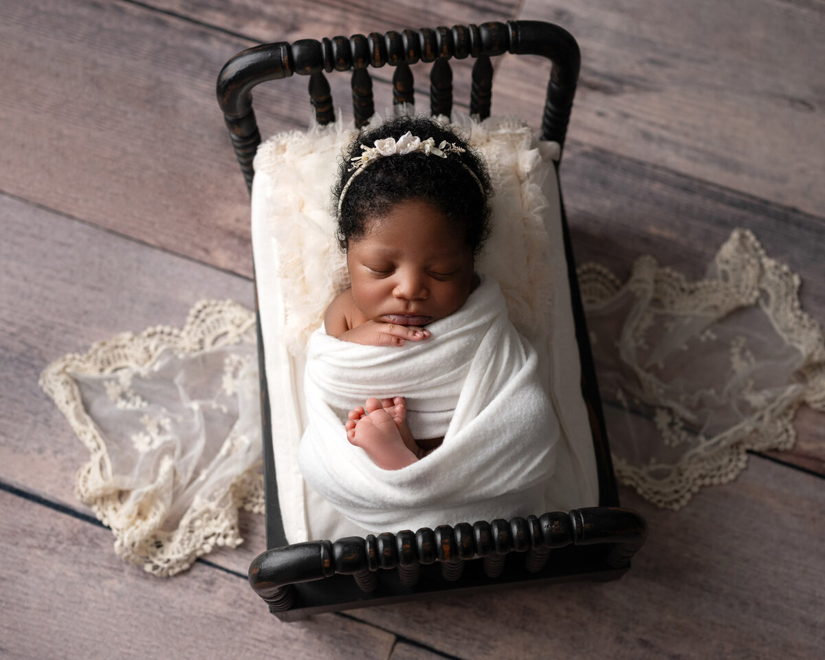 Newborn baby white wrap vintage bed Leander professional photographer