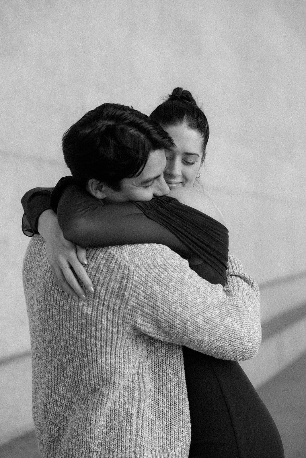 Woman hugs her new fiance tight after just saying yes to his proposal. 