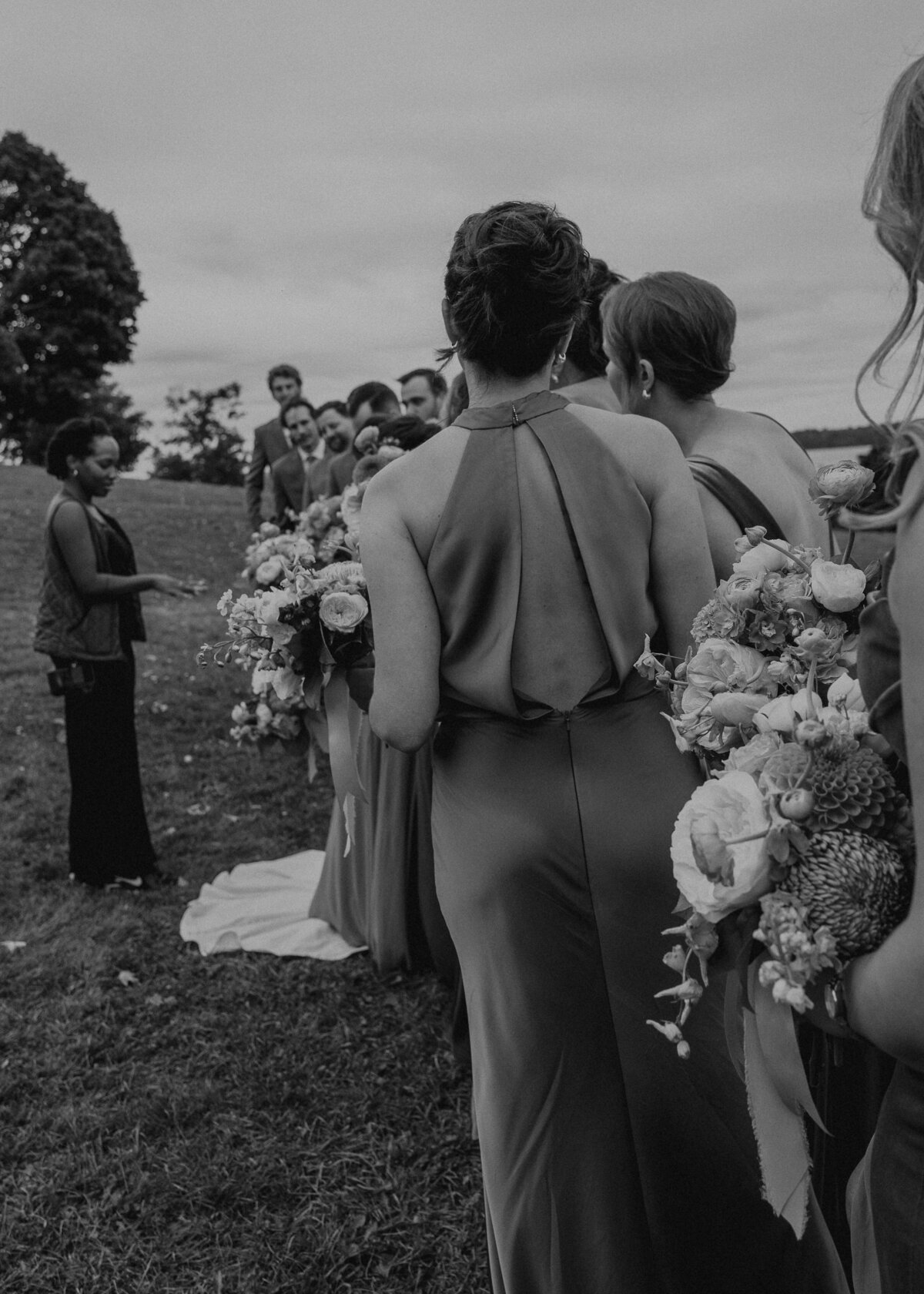 black and white photo of Jessica organizing the wedding party.