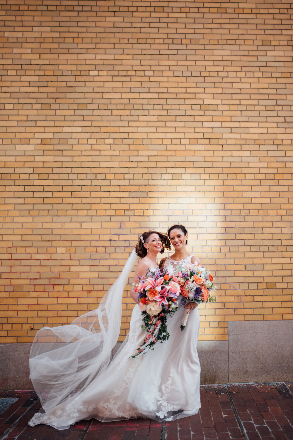 two brides stand posed in portland maine