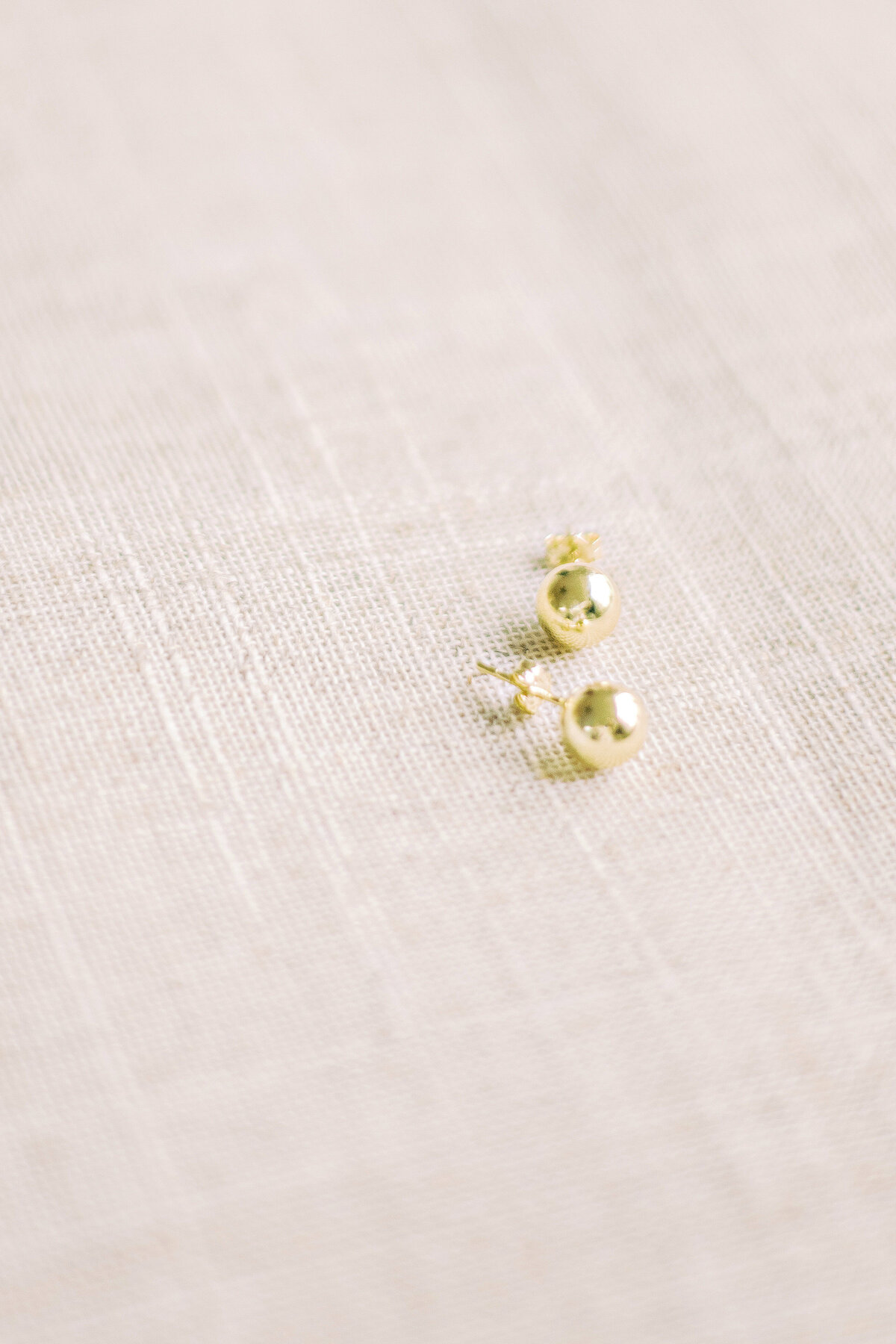 Earrings on a linen board in Burlington