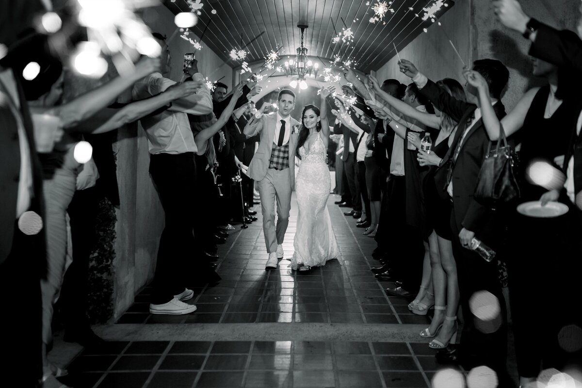 Bride and groom walking through a sparkler send off