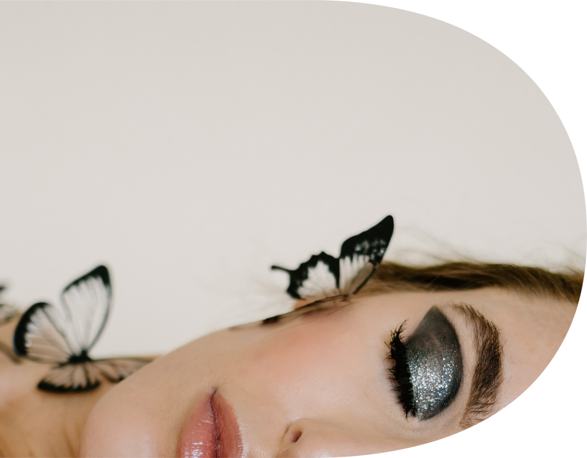 woman with dark eyeshadow and butterflies on her