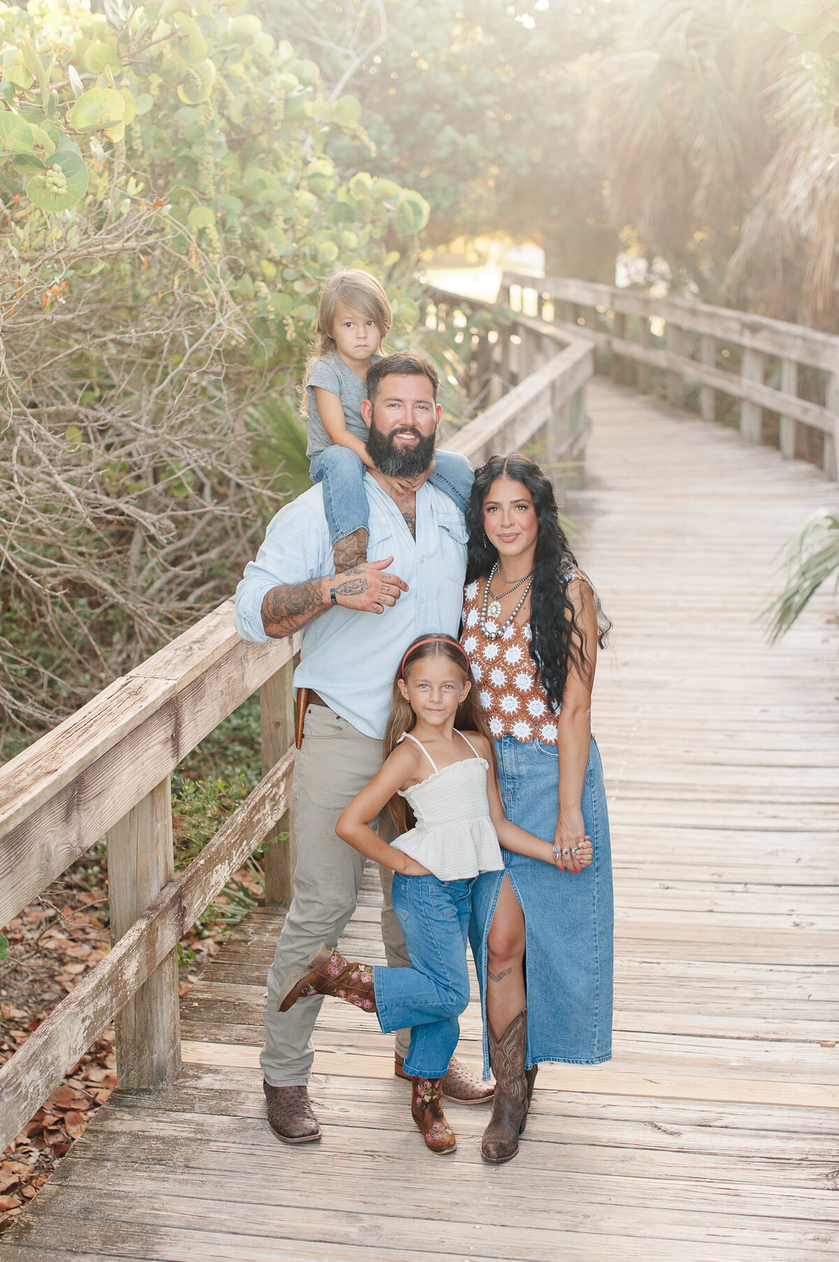 Family standing on the boardwalk smiling at the camera