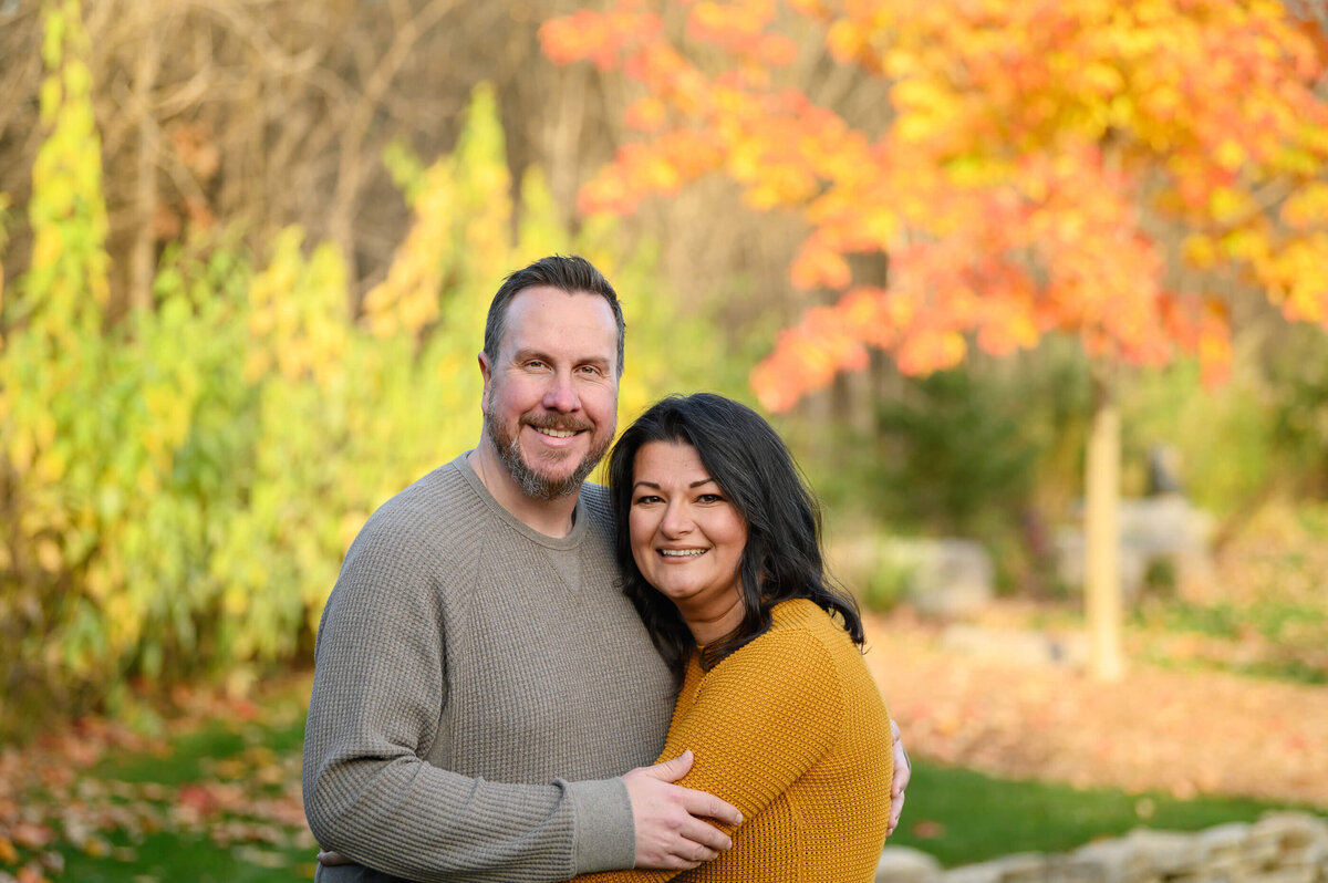 Husband and wife hugging for their Burlington, Fall family photography session