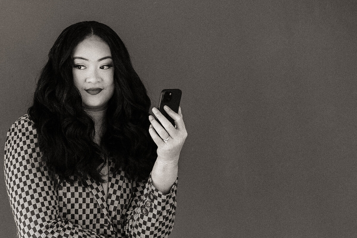 A woman holds her phone