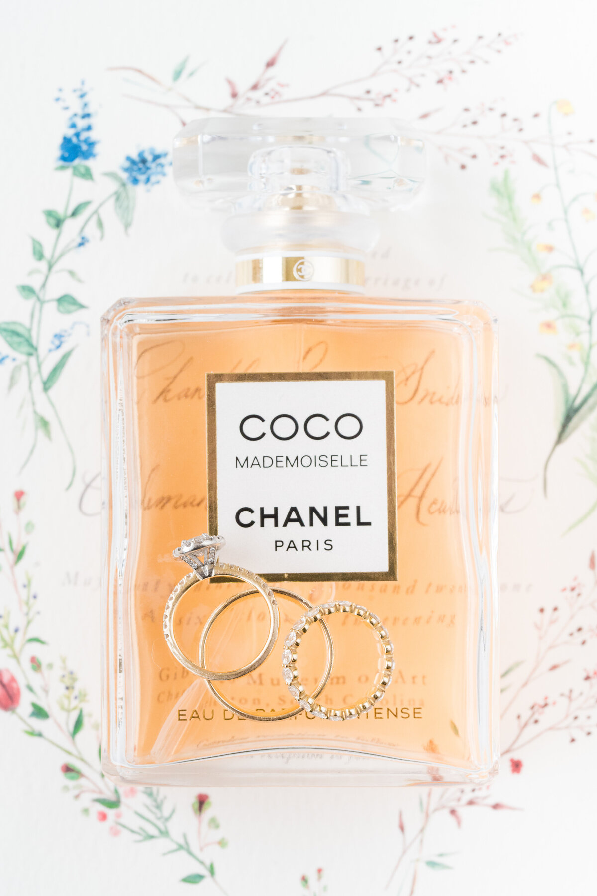wedding rings styled on chanel perfume bottle