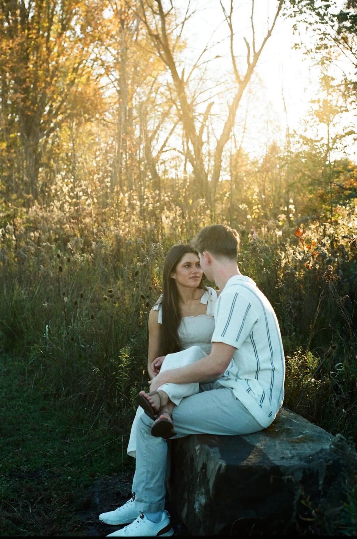 couple sitting together on boulder