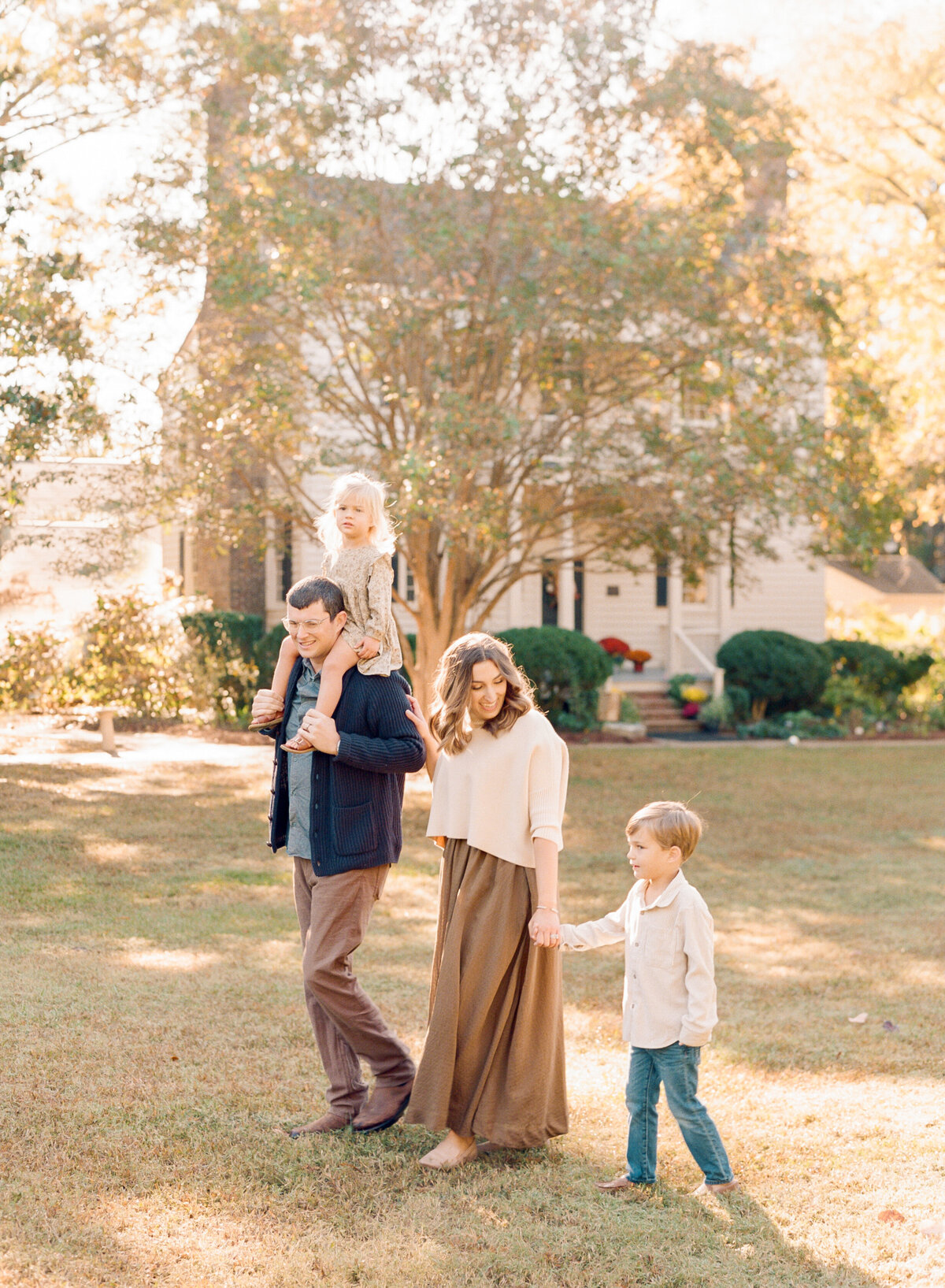 Family walks through Wake Forest birthplace during a family session. Image by Raleigh maternity photographer A.J. Dunlap Photography.