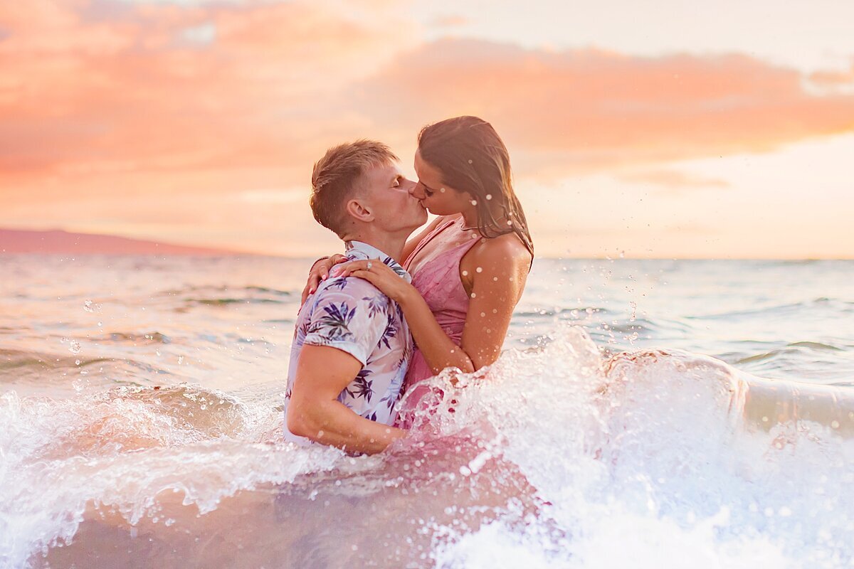 Intimate water portrait of a couple embracing in the ocean while having proposal portraits taken in Maui by Love + Water