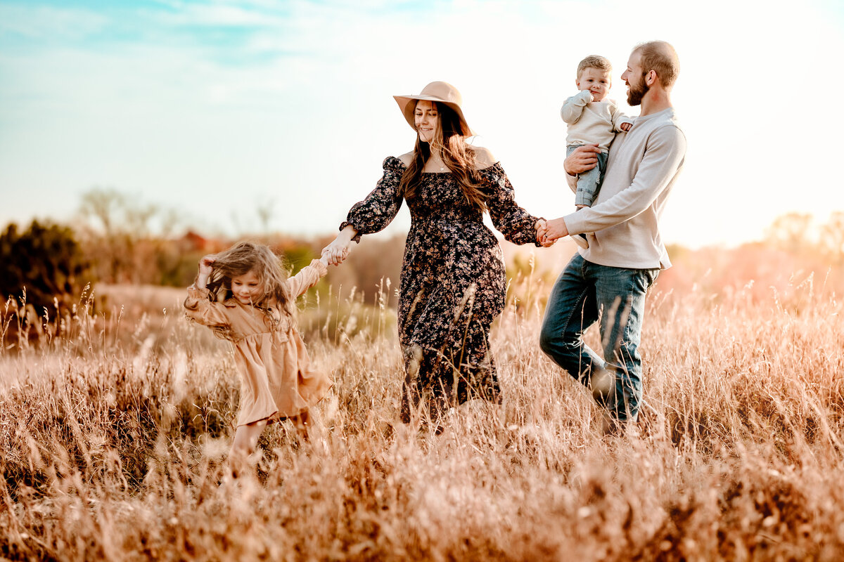 family playing in the golden sun
