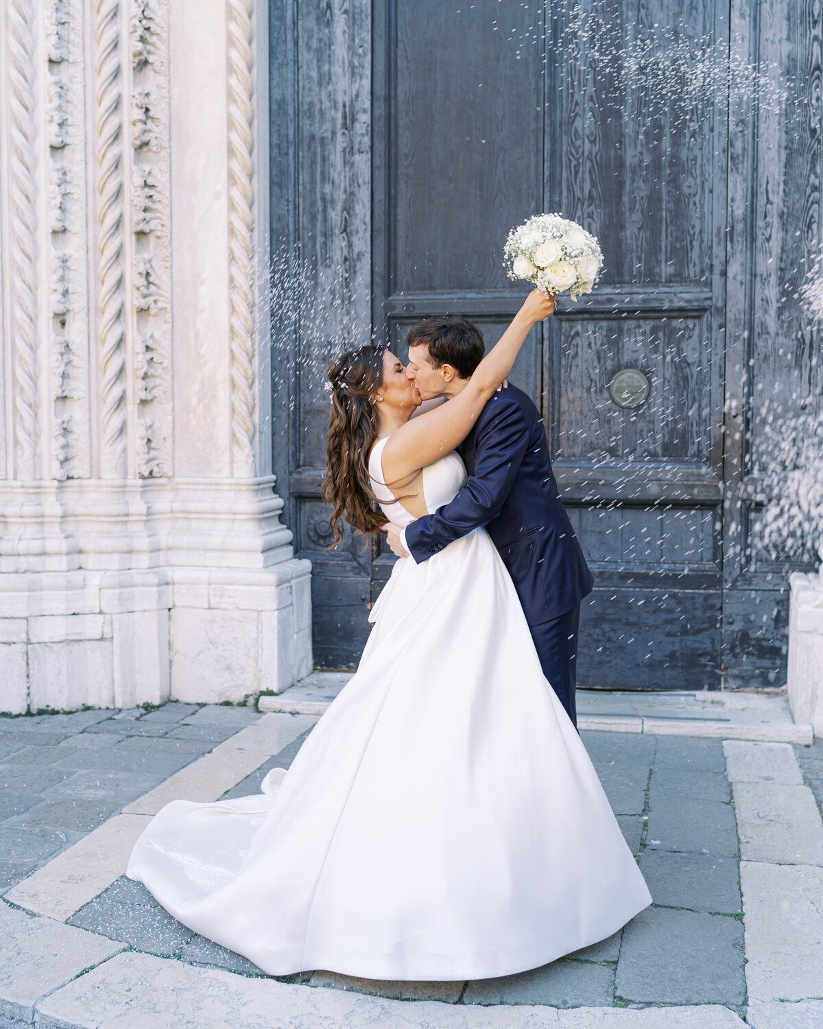 Confetti and kiss after church wedding in Venice
