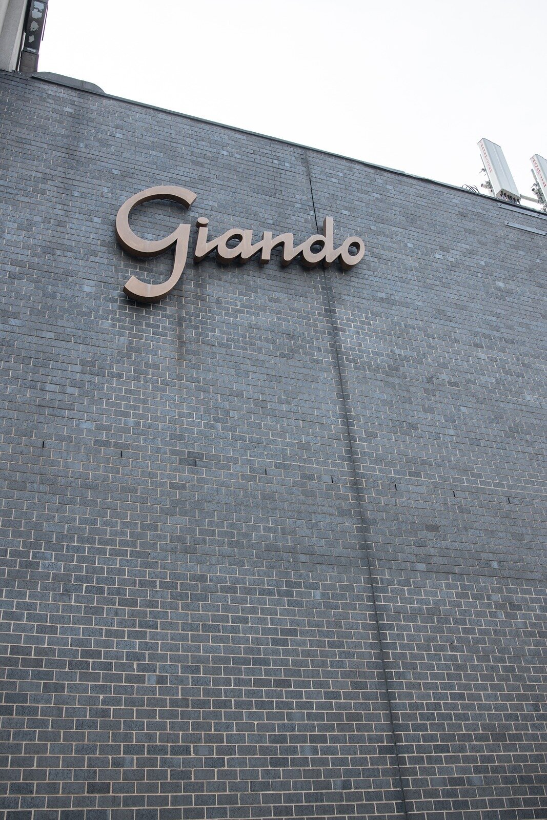 Giando on the Water wall with Giando sign.