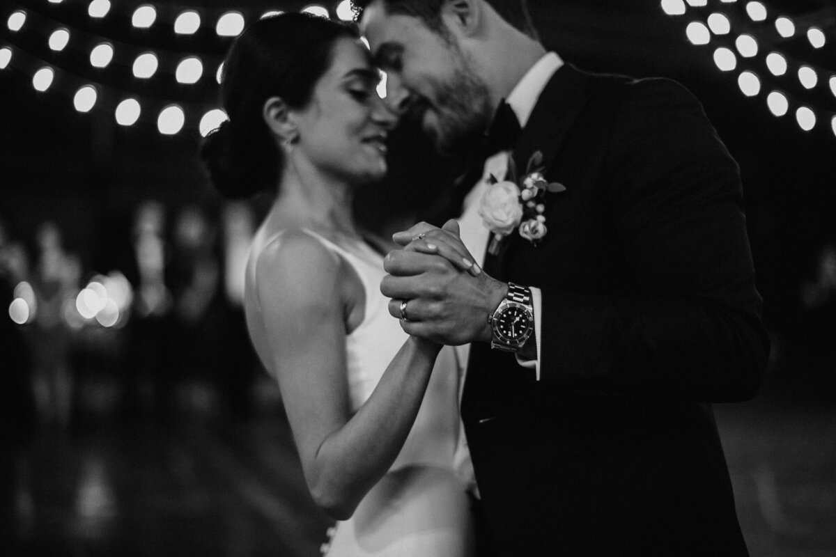 bride and groom first dance holding hands