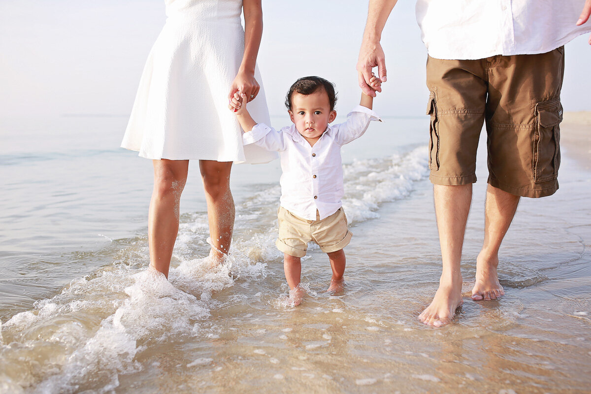 baby-boy-walking-with-parents