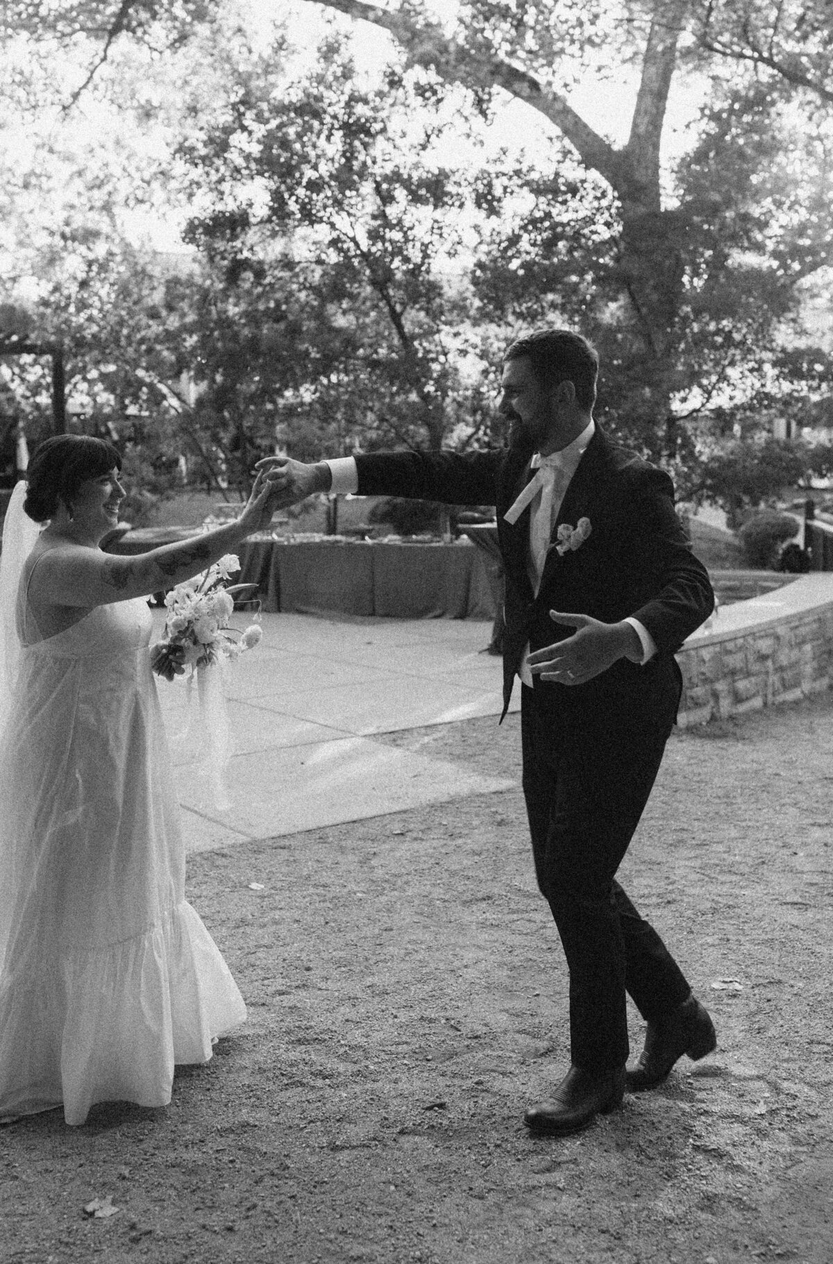 Bride and groom dancing at Couple portraits in the grounds of Umlauf Sculpture Garden wedding, Austin