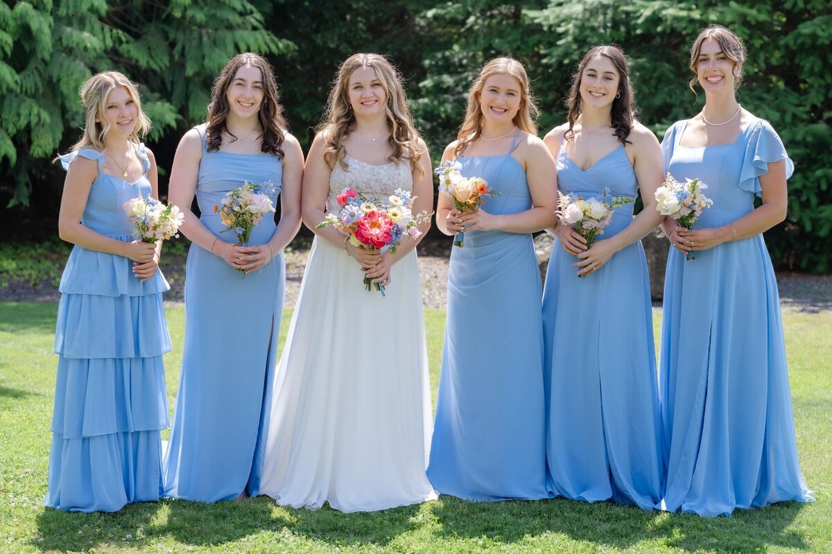 bride with bridesmaids in powder blue sunny wedding 