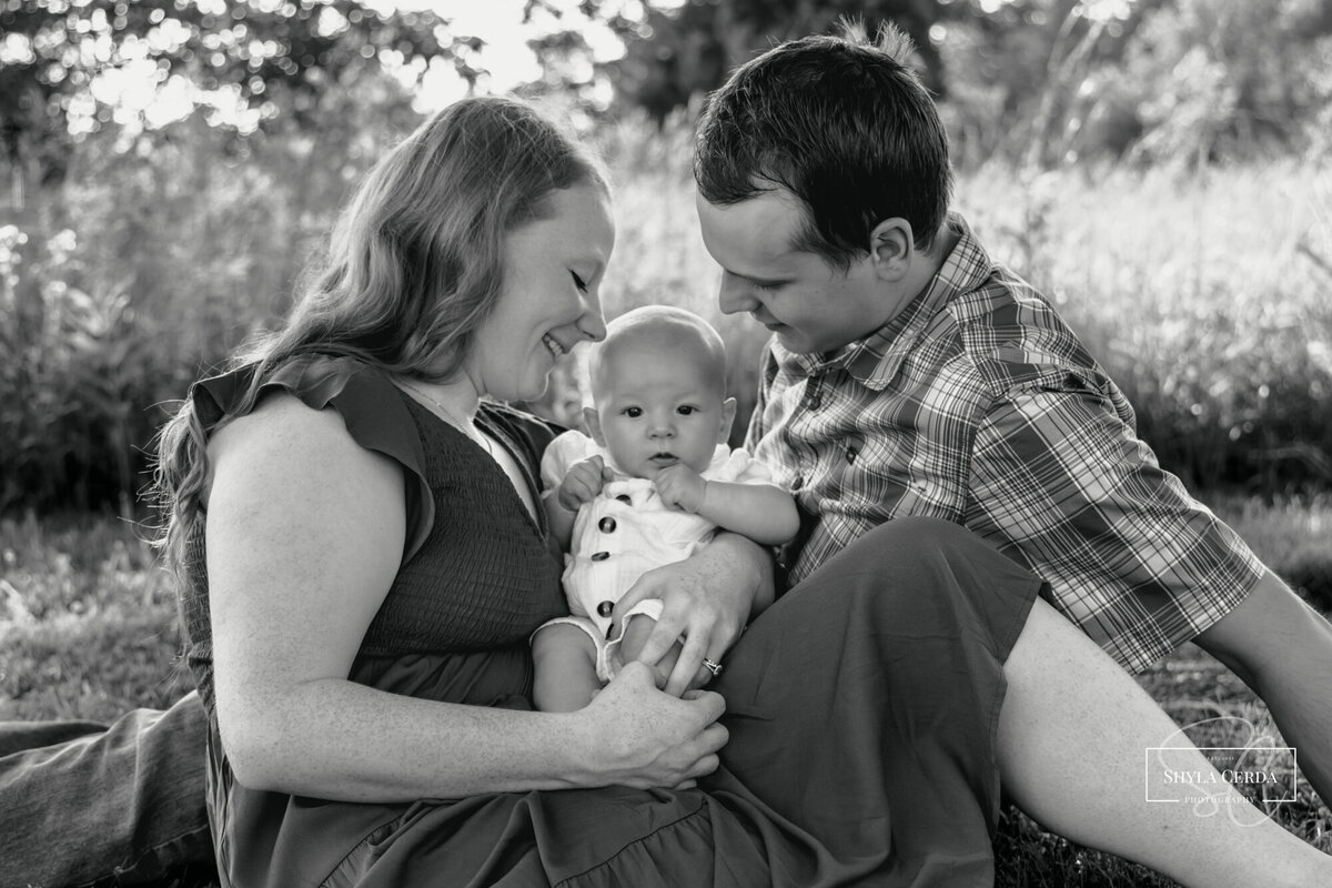 Young family snuggled in the shade at a Troy Ohio park