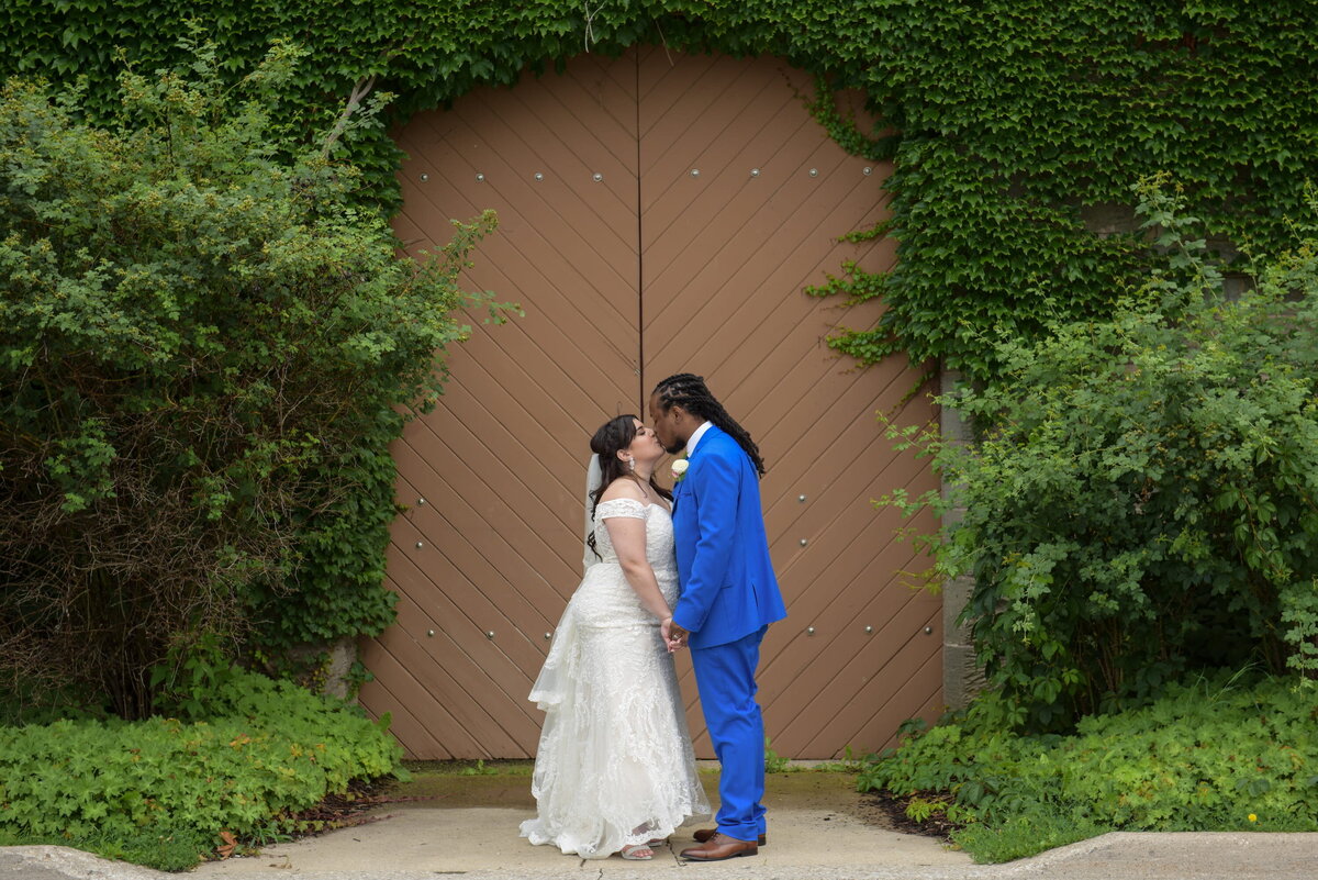intimate-wedding-kiss-bride-groom-green-door