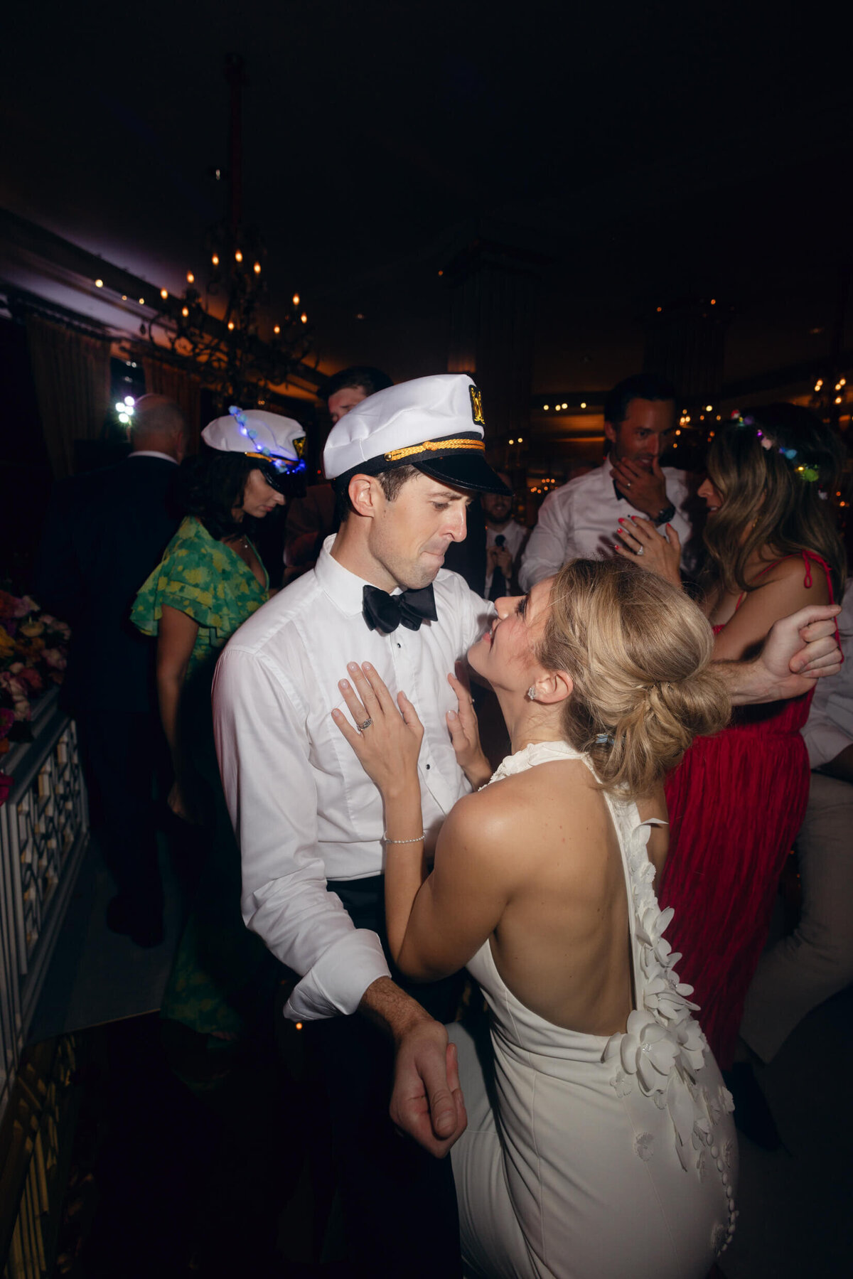 A wedding photo of the bride and groom during a candid moment during their wedding reception