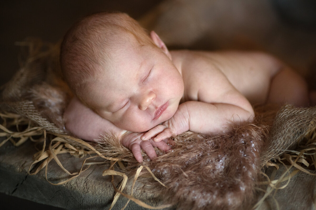 charming-newborn-baby-wooden-brown-background