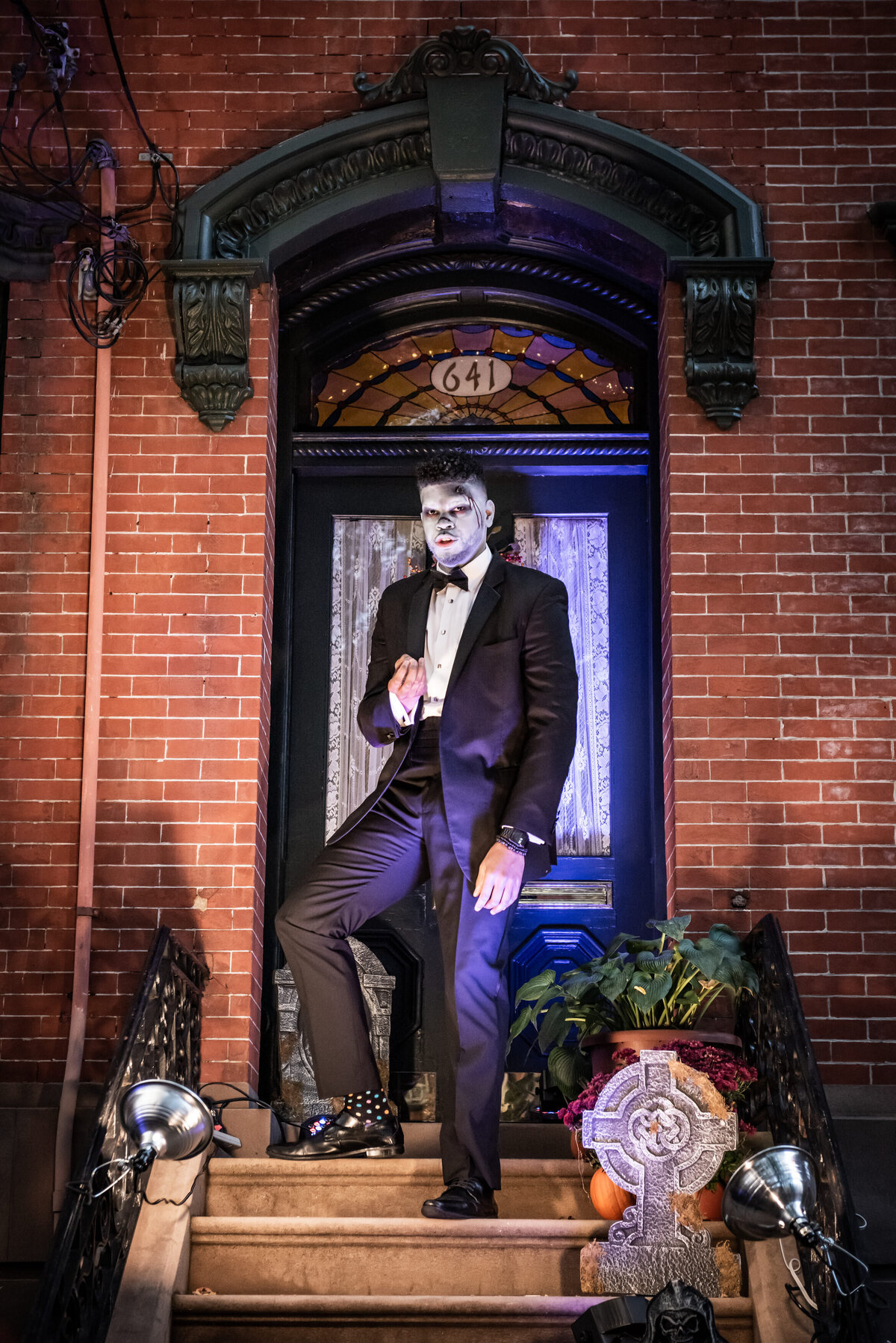 A person dressed up for halloween standing in a doorway