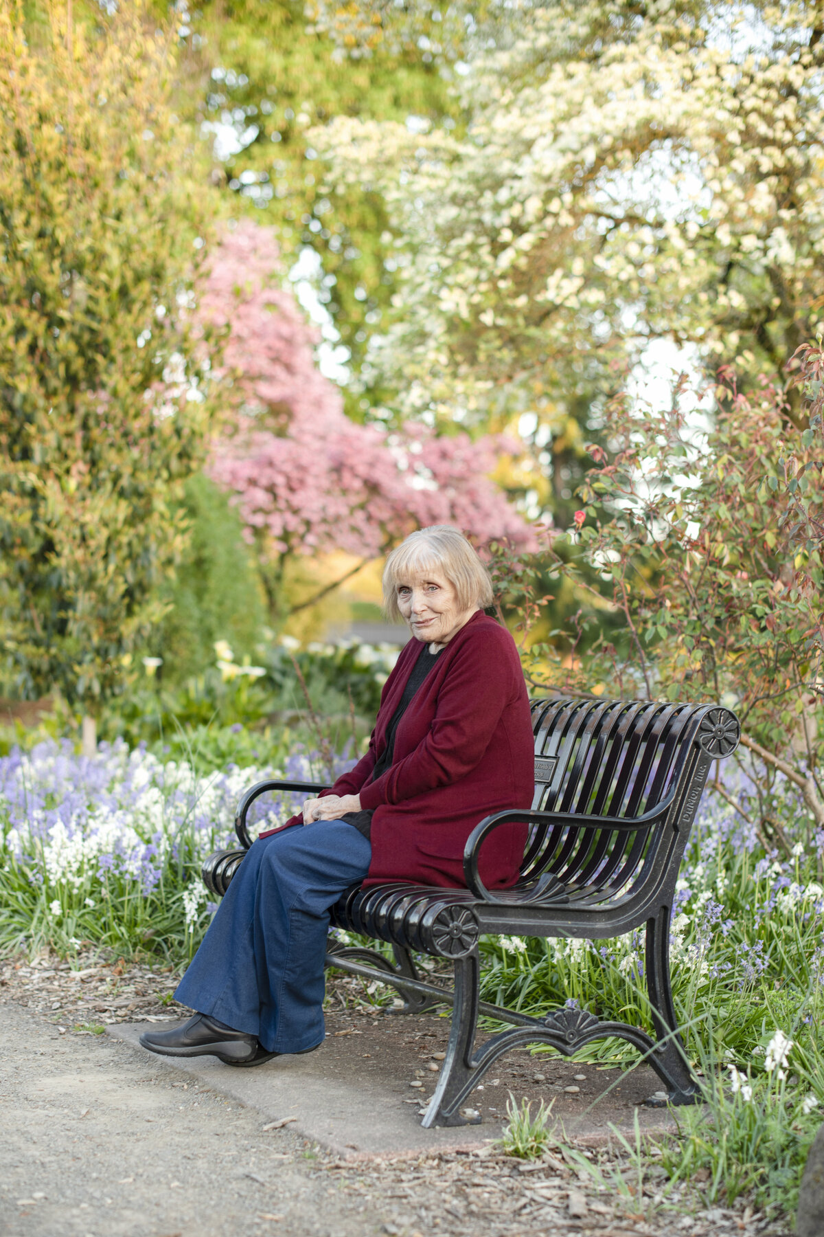 Grandma on the park bench surrounded by flowers at the Owen Rose Garden in Eugene Oregon