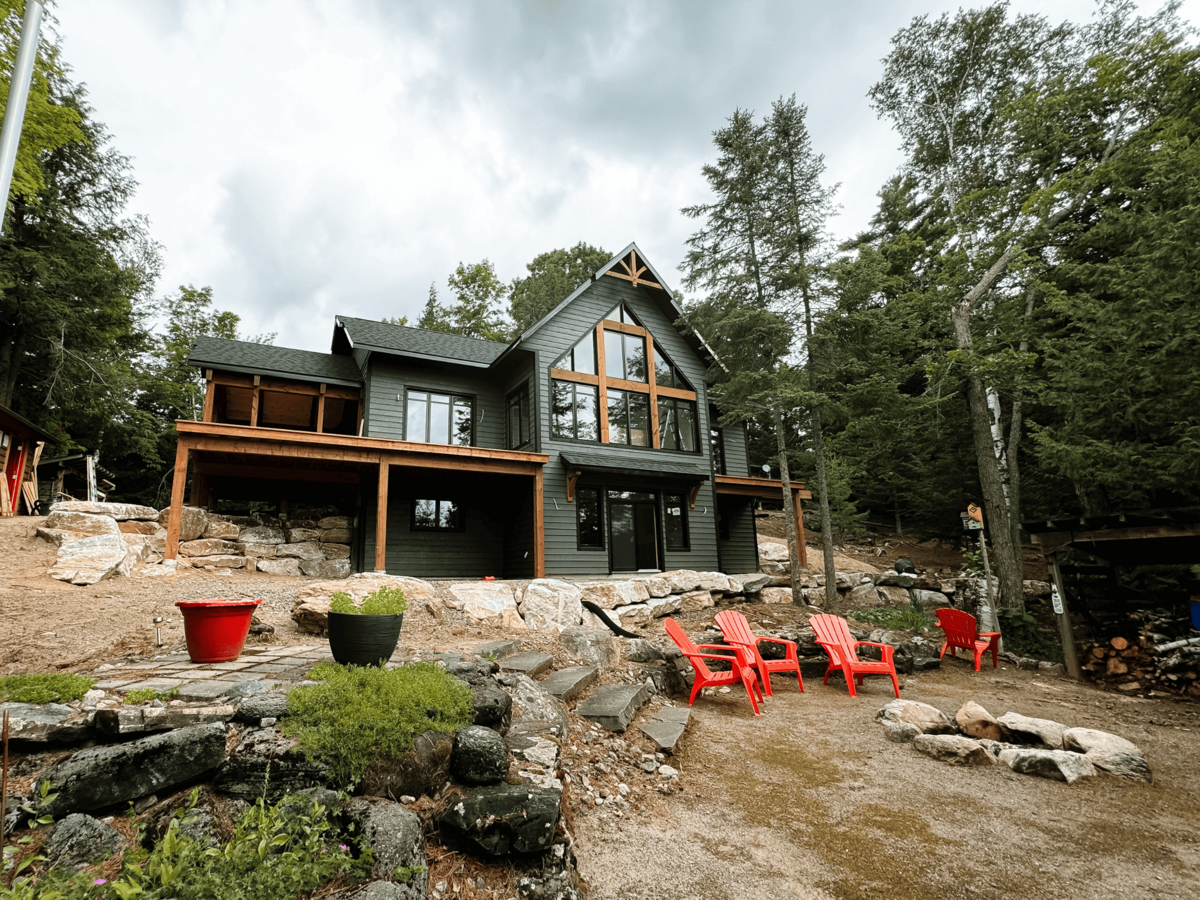 Timber-framed custom lakehouse in Haliburton Highlands designed for modern living with rustic charm and natural finishes.