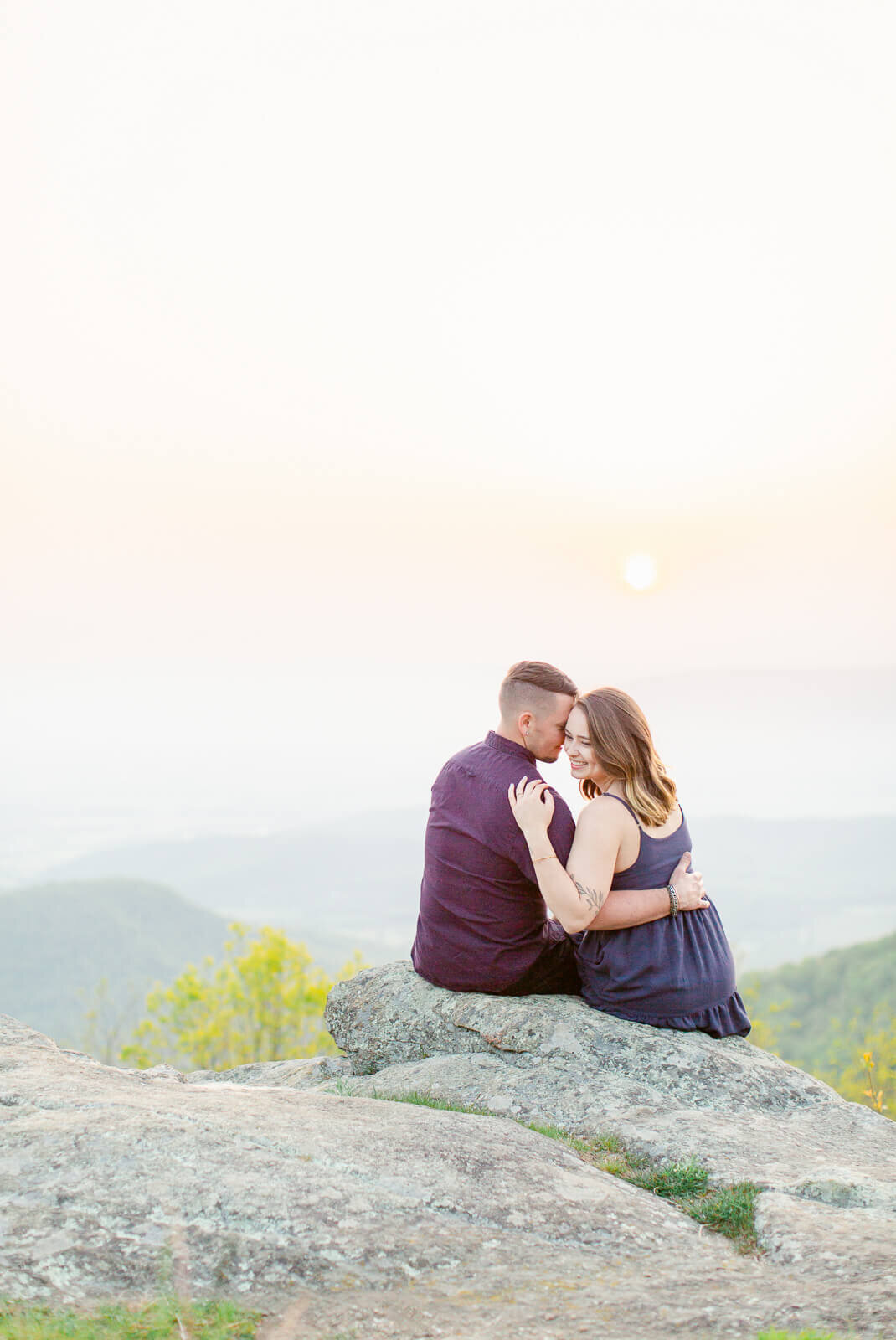 Couple taking Engagement Photos in Shenandoah National Park. Captured by Bethany Aubre Photography.