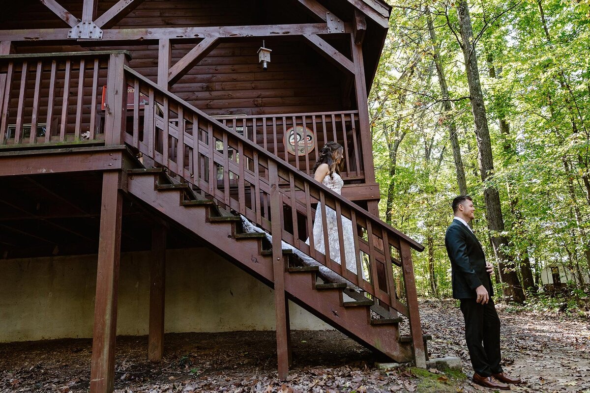 A bride walks down the cabin stairs to see her groom for the first time on their wedding day,
