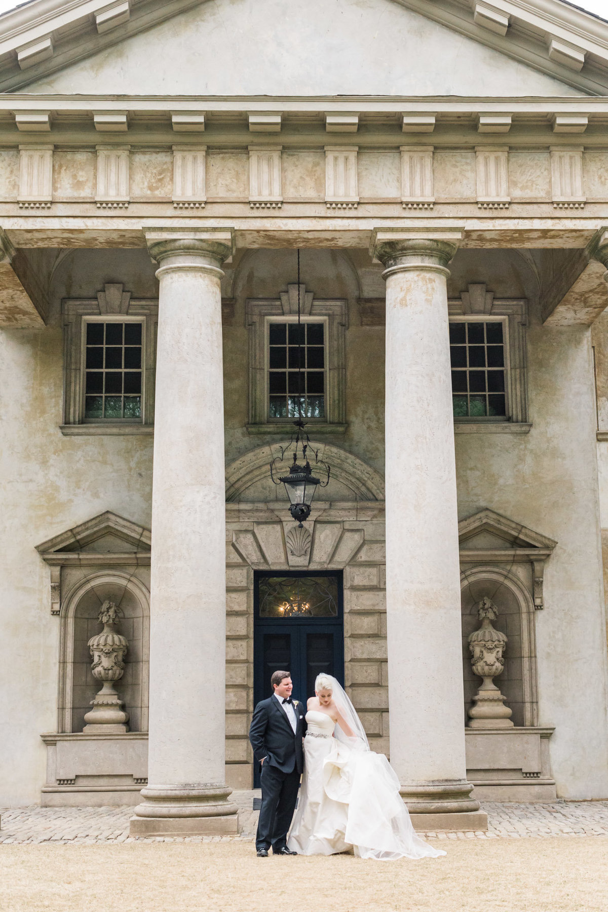 Romantic bride and groom photos in front of the Swan House. Photo by luxury destination wedding photographer Rebecca Cerasani.
