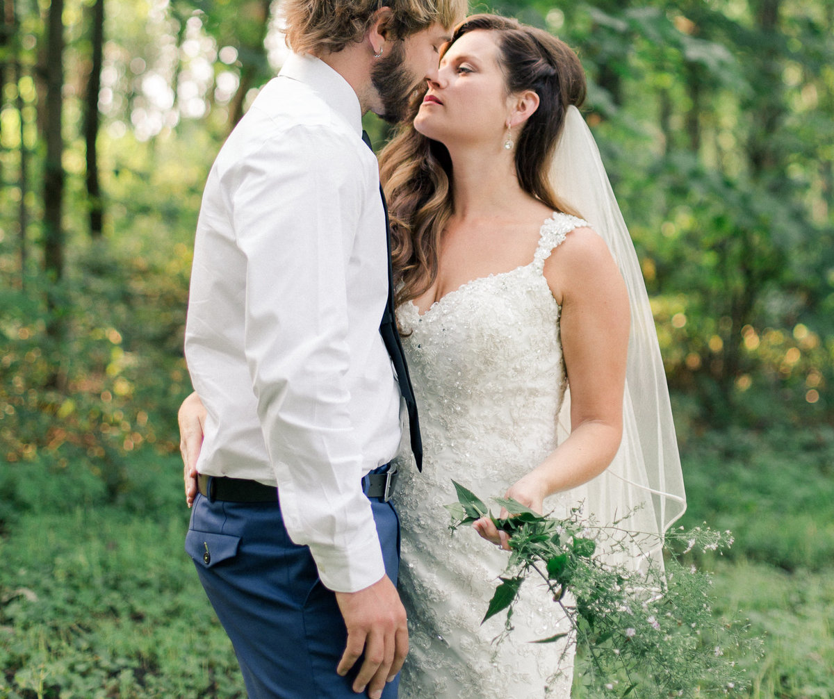 backyard wedding of bride and groom in the summer woods