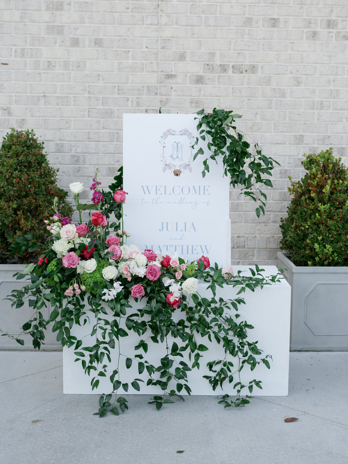 white welcome sign with pink  flowers