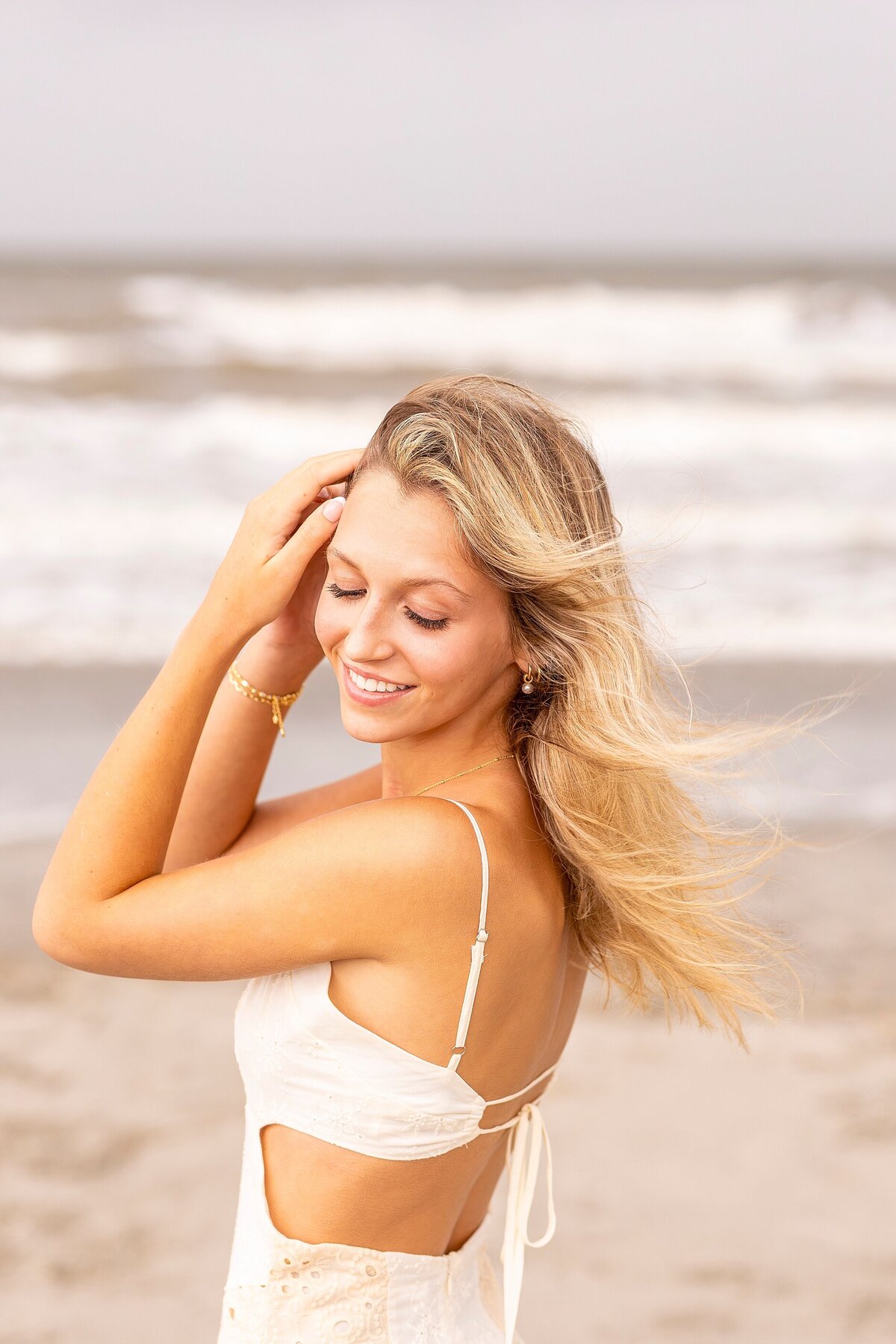 Senior portrait session in Charleston at Folly Beach with golden light and natural coastal charm