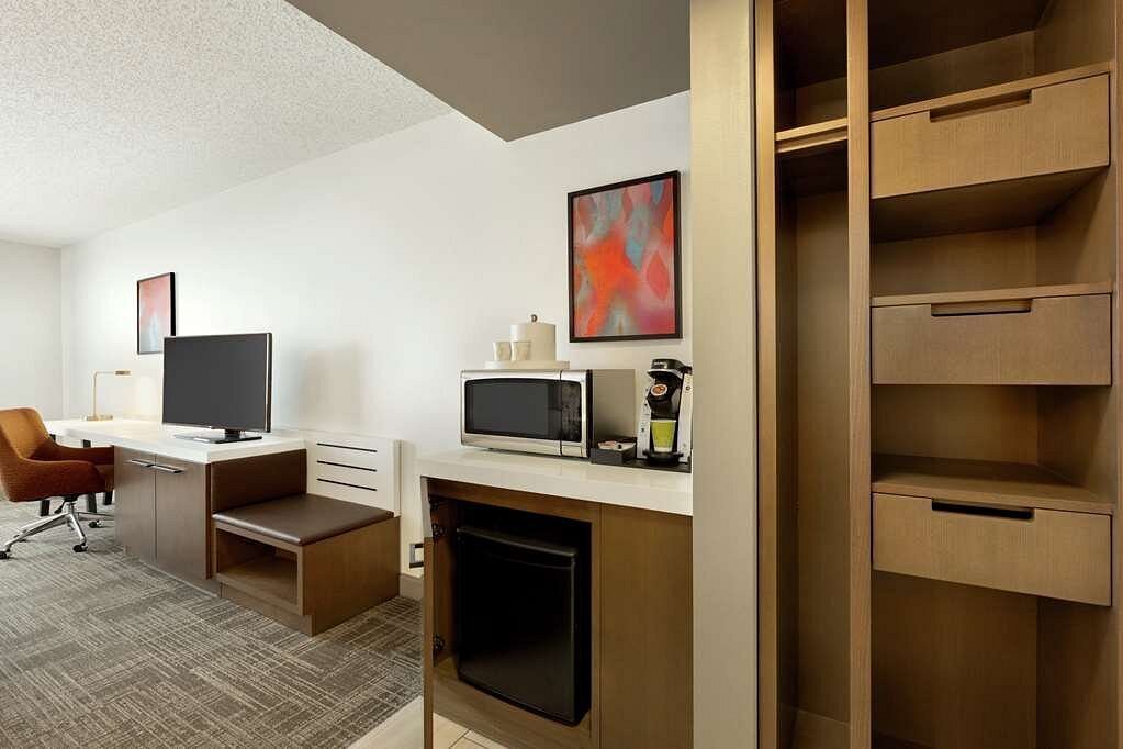 Modern hotel guest room casegoods with microwave and mini fridge