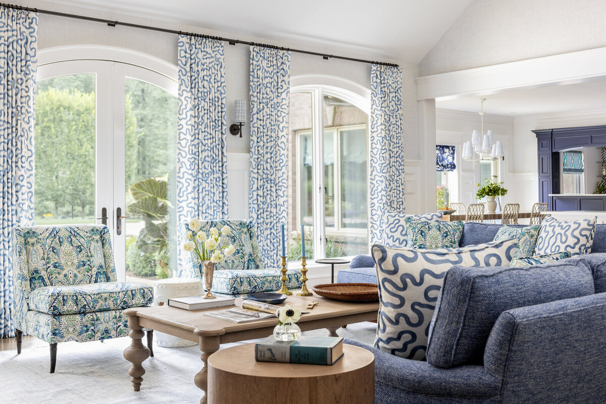Heavily patterned living room interior with a lot of blue green and white accents.