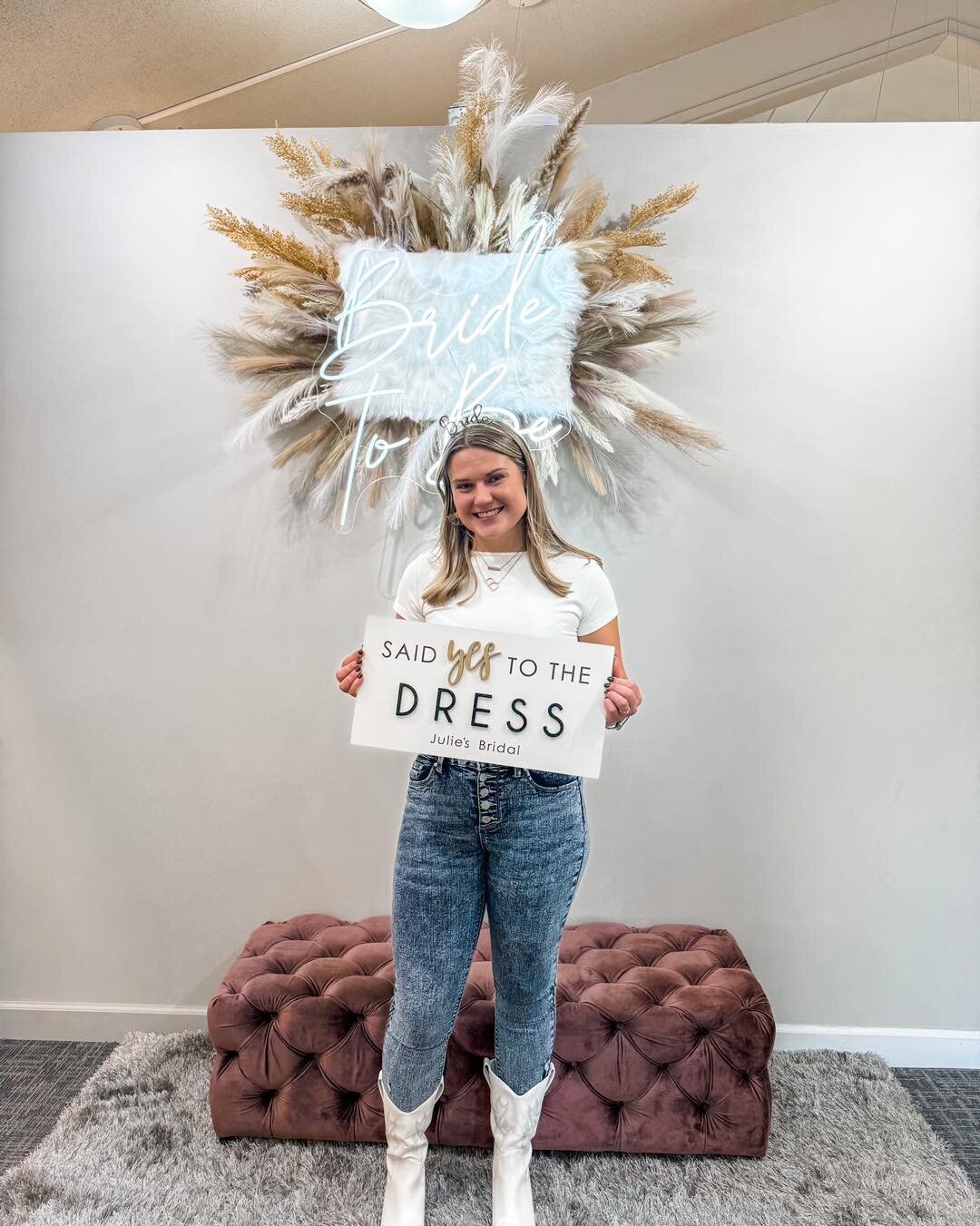 VIP Bride holding said "yes to the dress" sign at Julie's Bridal in Monroe Wi