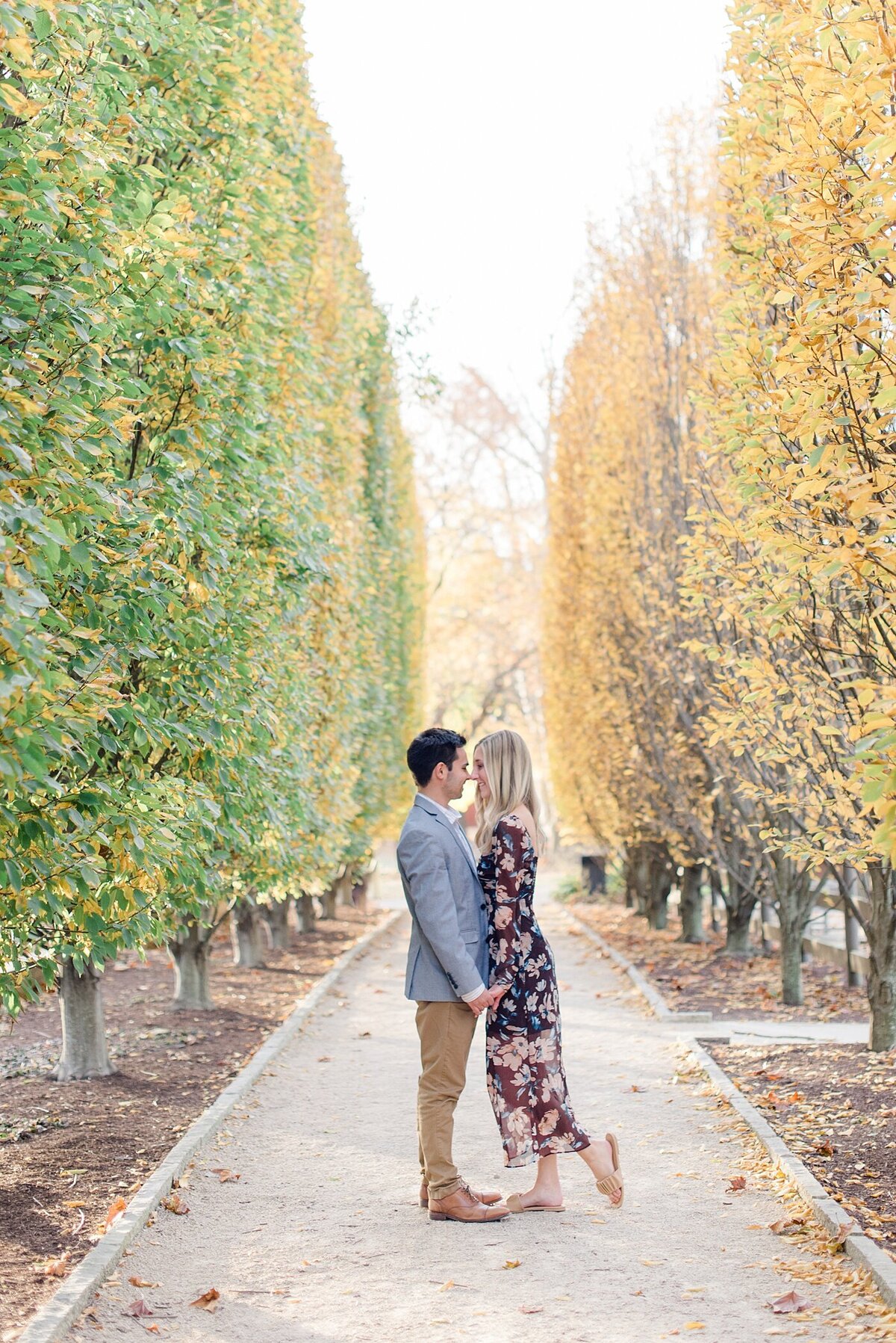 Couple posing on tree line path during Columbus, Ohio engagement session at Franklin Park