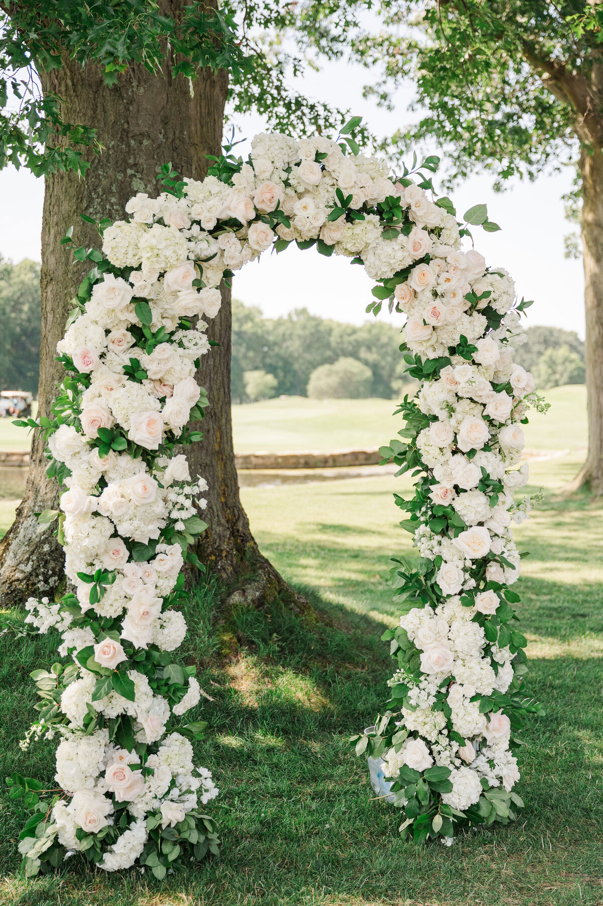wedding floral arch setup outside of The Grand Resort by sapphire and lace