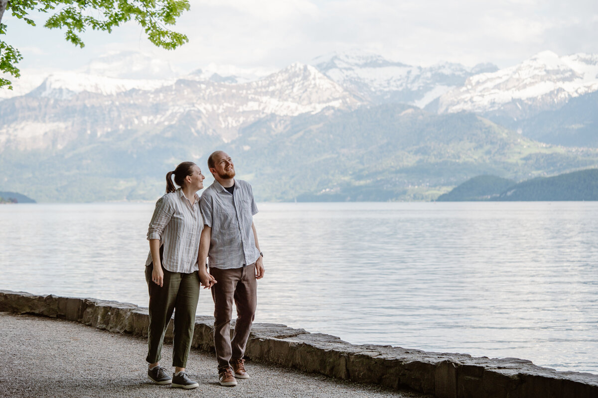A couple walking along the edge of a lake