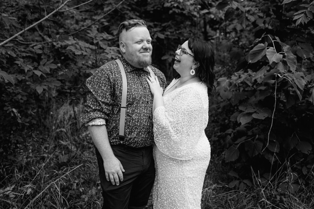 lake erie elopement bride and groom smile in black and white
